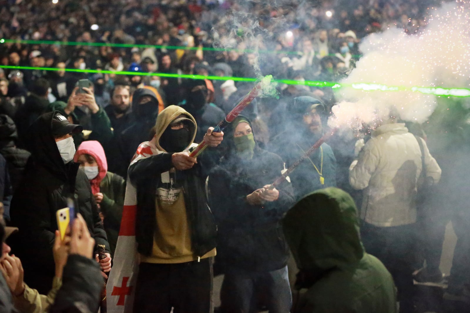 Demonstrators stand in front of police during a rally outside the parliament's building to protest the government's decision to suspend negotiations on joining the European Union for four years in Tbilisi, Georgia, on Saturday, Nov. 30, 2024. (AP Photo/Zurab Tsertsvadze)