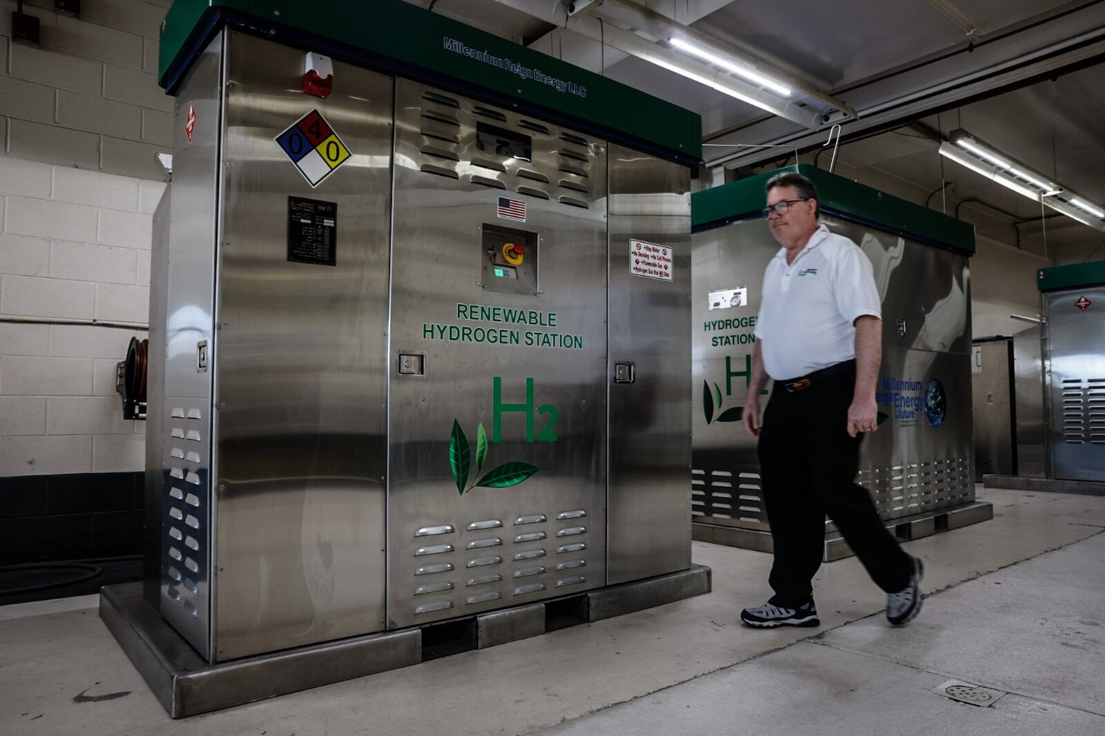 Founder and CEO of Millennium Reign Energy walks by a Renewable Hydrogen Station that is company builds on North Main Street in Dayton Friday July 19, 2024. JIM NOELKER/STAFF