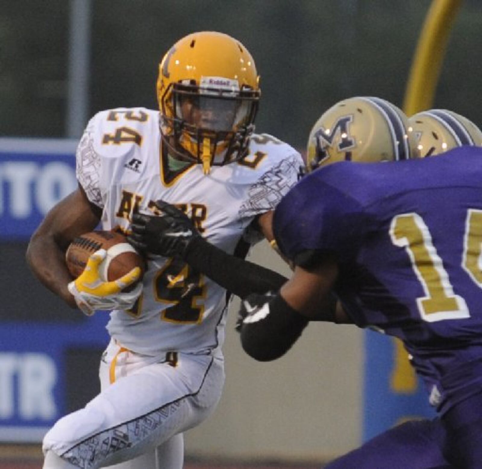 Alter running back Nick Coleman squares off against Thurgood Marshall defender Michael Ivy (14). Alter defeated Thurgood 42-14 in a high school football game at Welcome Stadium on Friday, Sept. 12, 2014. MARC PENDLETON / STAFF