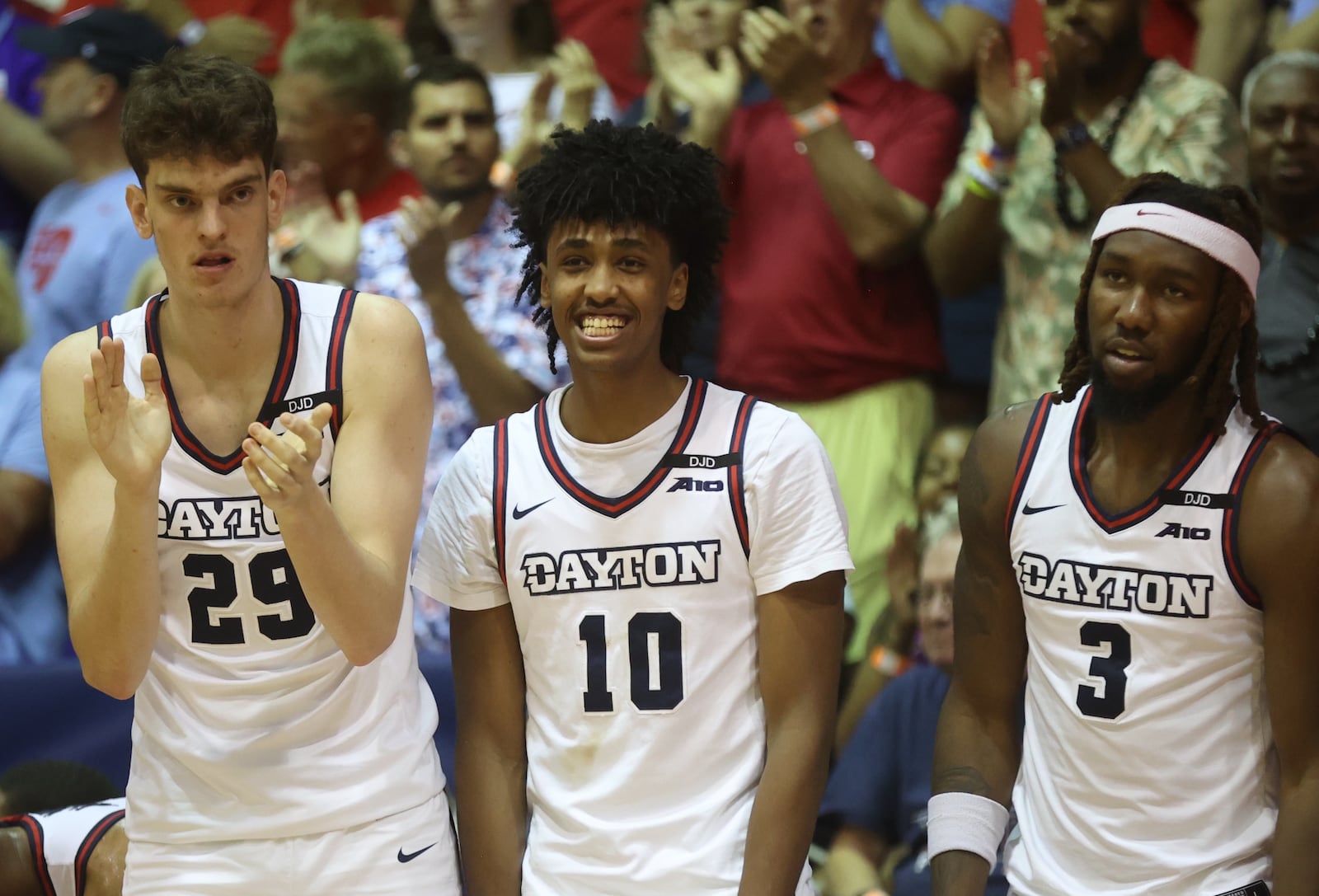 Dayton's Amael L'Etang, Hamad Mousa and Jaiun Simon react after a basket against Connecticut in the Maui Invitational on Wednesday, Nov. 27, 2024, at the Lahaina Civic Center. David Jablonski/Staff