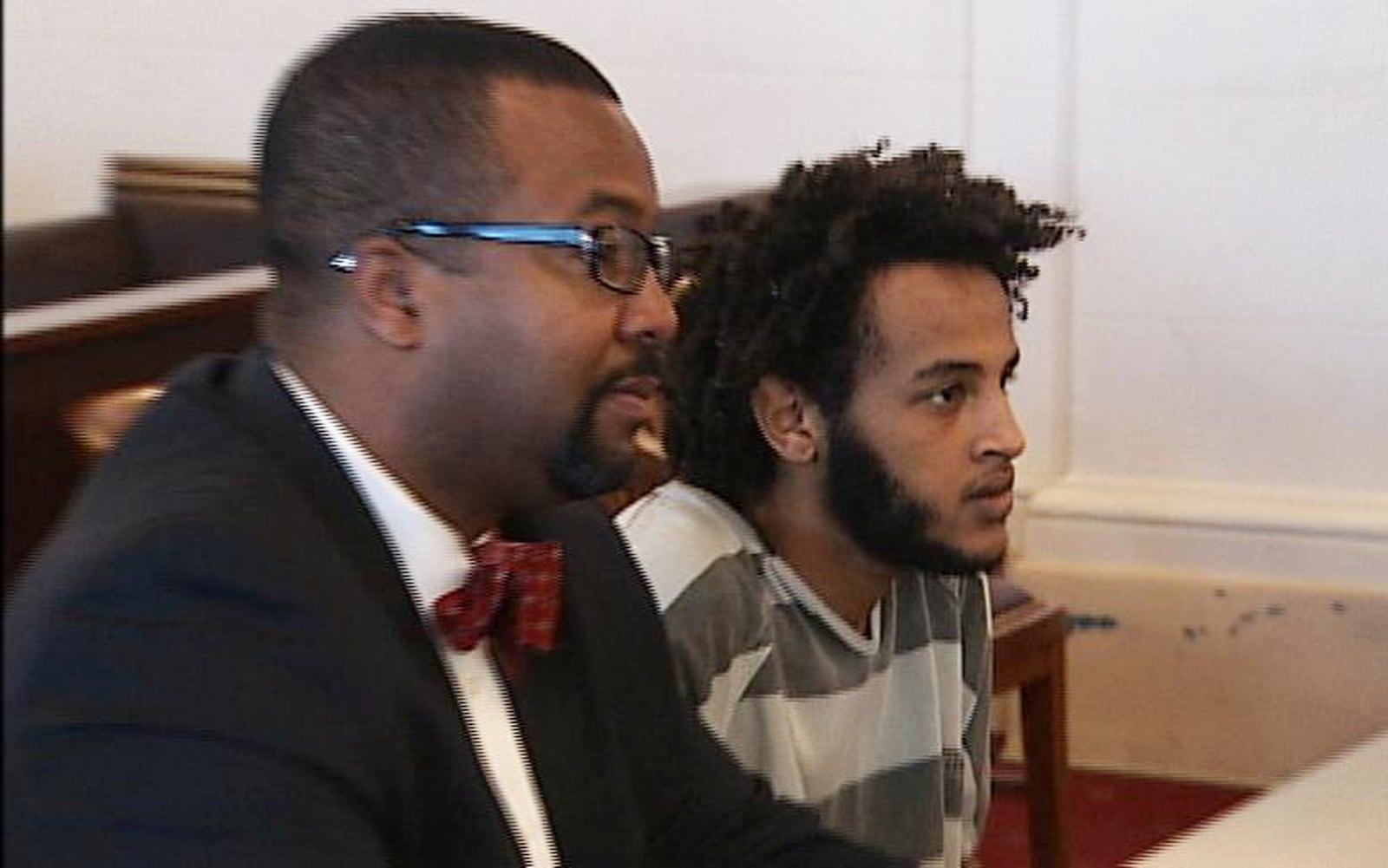 Belule Ayele and his attorney Anthony VanNoy listen as Judge Douglas Ratstatter finds Ayele not guilty by reason of insanity. Ayele was ordered to a mental health facility for treatment. He was deported in April. JEFF GUERINI / STAFF