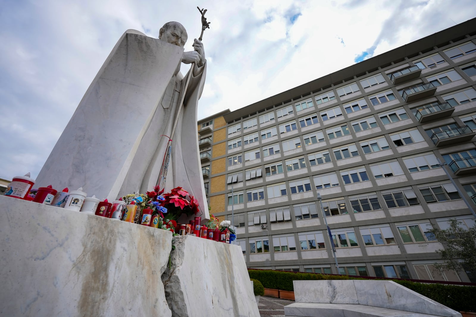 A statue of Pope John Paul II is seen in front of the Agostino Gemelli Polyclinic, in Rome, Monday, Feb. 17, 2025, where Pope Francis has been hospitalized to undergo some necessary diagnostic tests and to continue his ongoing treatment for bronchitis. (AP Photo/Andrew Medichini)