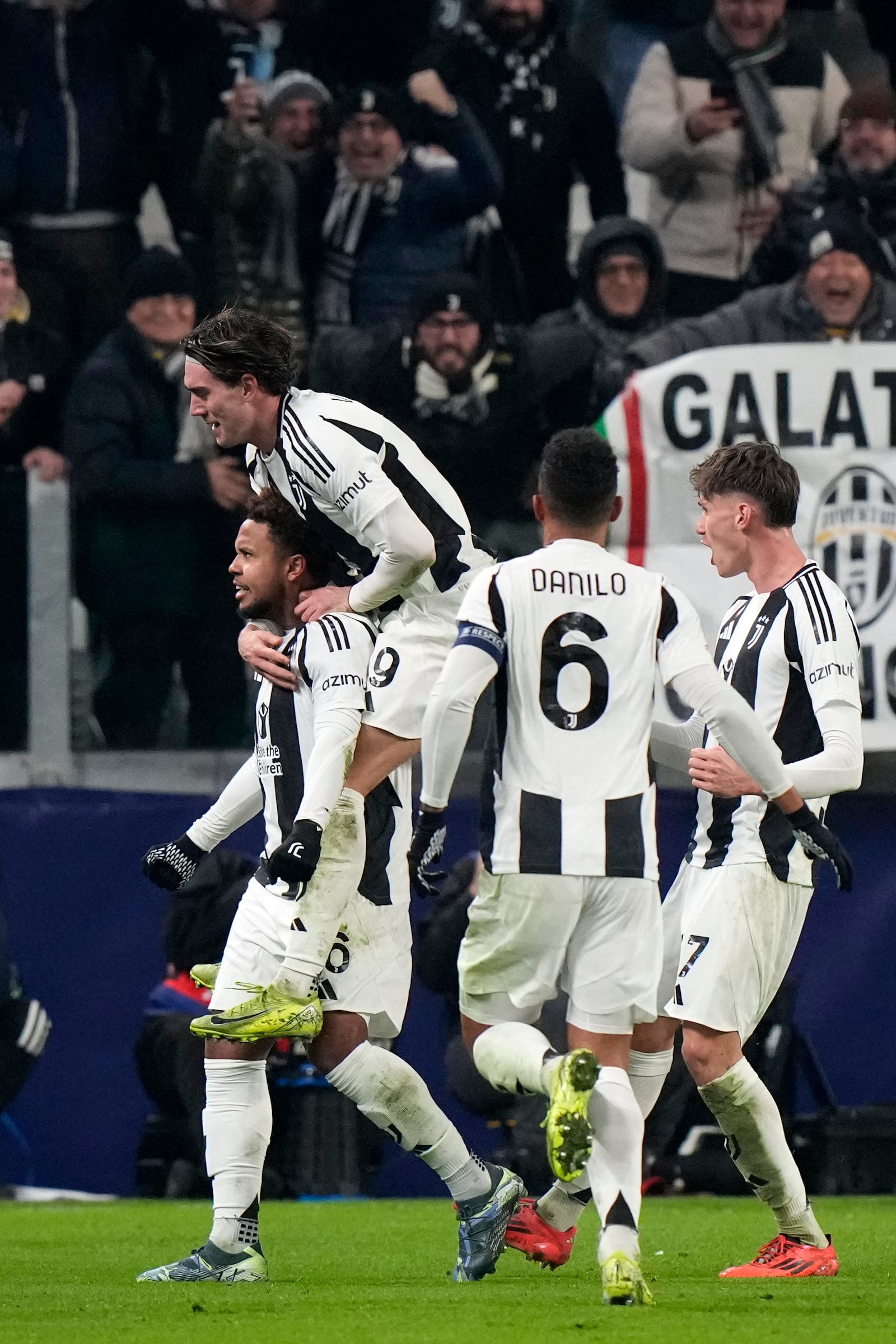 Juventus' Weston McKennie, left, and Dusan Vlahovic, top, celebrate with teammates their side's second goal during the Champions League, opening phase soccer match between Juventus and Manchester City at the Allianz stadium in Turin, Italy, Tuesday, Wednesday, Dec.11, 2024. (AP Photo/Luca Bruno)