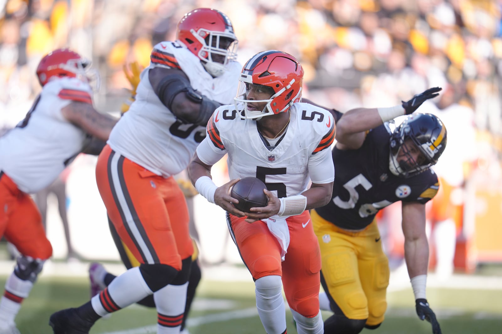 Cleveland Browns quarterback Jameis Winston (5) rolls out in front of Pittsburgh Steelers linebacker Alex Highsmith (56) in the first half of an NFL football game in Pittsburgh, Sunday, Dec. 8, 2024. (AP Photo/Gene J. Puskar)