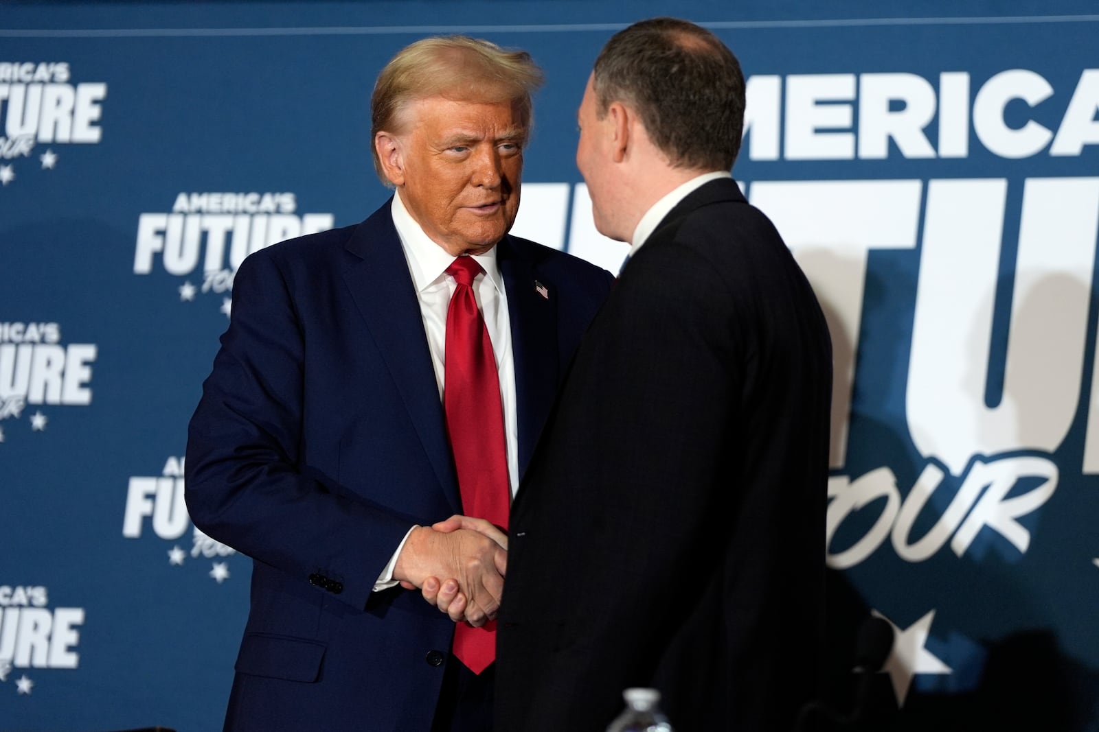 Republican presidential nominee former President Donald Trump shakes hands with former Rep. Lee Zeldin, R-N.Y., during a roundtable at the Drexelbrook Catering & Event Center, Tuesday, Oct. 29, 2024, in Drexel Hill, Pa. (AP Photo/Julia Demaree Nikhinson)