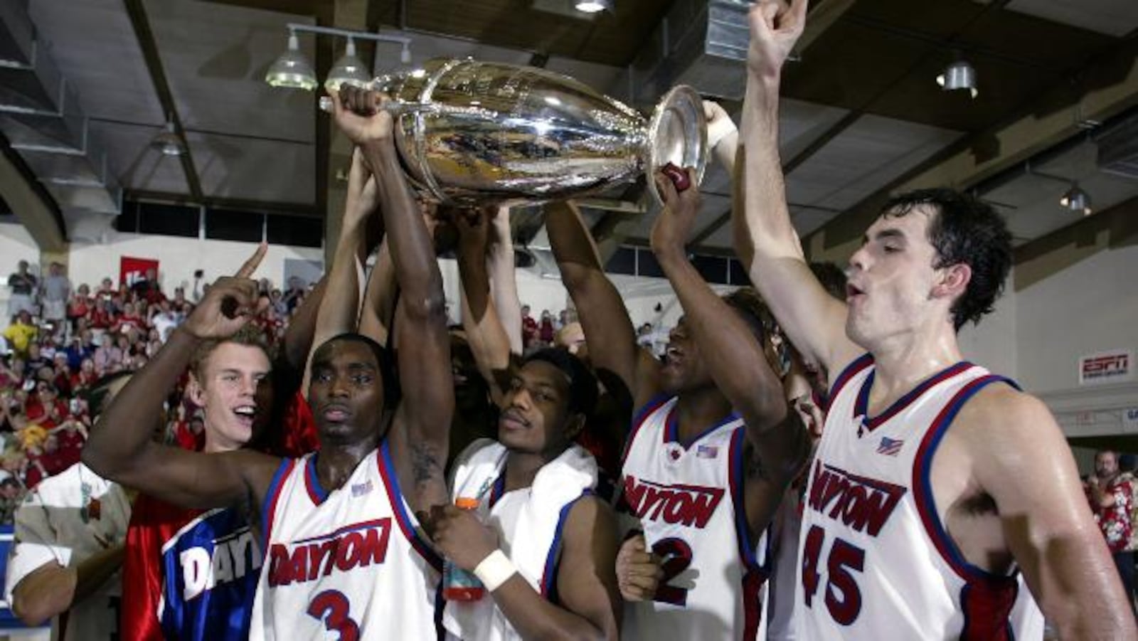 Dayton players, from left to right, Greg Kohls, Ramod Marshall, Warren Williams, Frank Iguodala and Keith Waleskowski celebrates with the championship trophy after defeating Hawaii 82-72 in the championship game at the Maui Invitational in Lahaina, Hawaii Wednesday, Nov. 26, 2003.   (AP Photo/Michael Conroy)