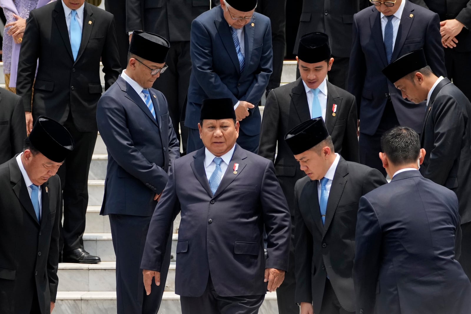 Indonesian President Prabowo Subianto, center, takes his position for a group photo with newly-appointed cabinet ministers after their swearing-in ceremony at Merdeka Palace in Jakarta, Indonesia, Monday, Oct. 21, 2024. (AP Photo/Achmad Ibrahim)