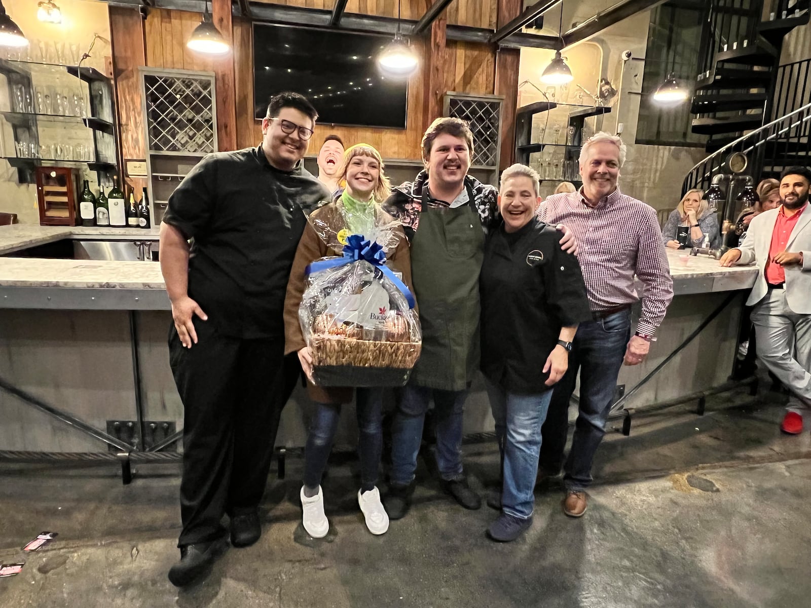 Wheat Penny chef Nicholas Cheng, sous chef Hannah Cranmer, bar manager Thomas Morris and chef and co-owner 
Liz Valenti receive a Buckeye Vodka gift basket from Jim Finke from Buckeye Vodka. Wheat Penny's cocktail, "Stop and Smell the Roses" made with rose hip, black tea and cardamom infused vodka with punt e mes (an Italian vermouth), housemade orgeat, lemon, grapefruit, Earl Gray tea and rose water topped off with a sea salt foam took home top prize. ALEXIS LARSEN/CONTRIBUTOR