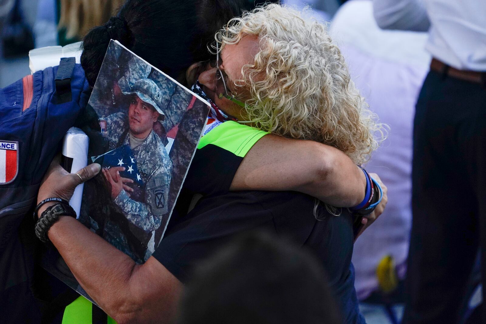 People react as they attend a ceremony marking the 20th anniversary of the Sept. 11, 2001, terrorist attacks at the National September 11 Memorial and Museum in New York, Saturday, Sept. 11, 2021. (AP Photo/Evan Vucci)