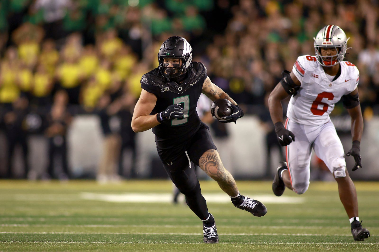 Oregon tight end Terrance Ferguson, left, runs the ball downfield against Ohio State safety Sonny Styles (6) during an NCAA college football game, Saturday, Oct. 12, 2024, in Eugene, Ore. (AP Photo/Lydia Ely)