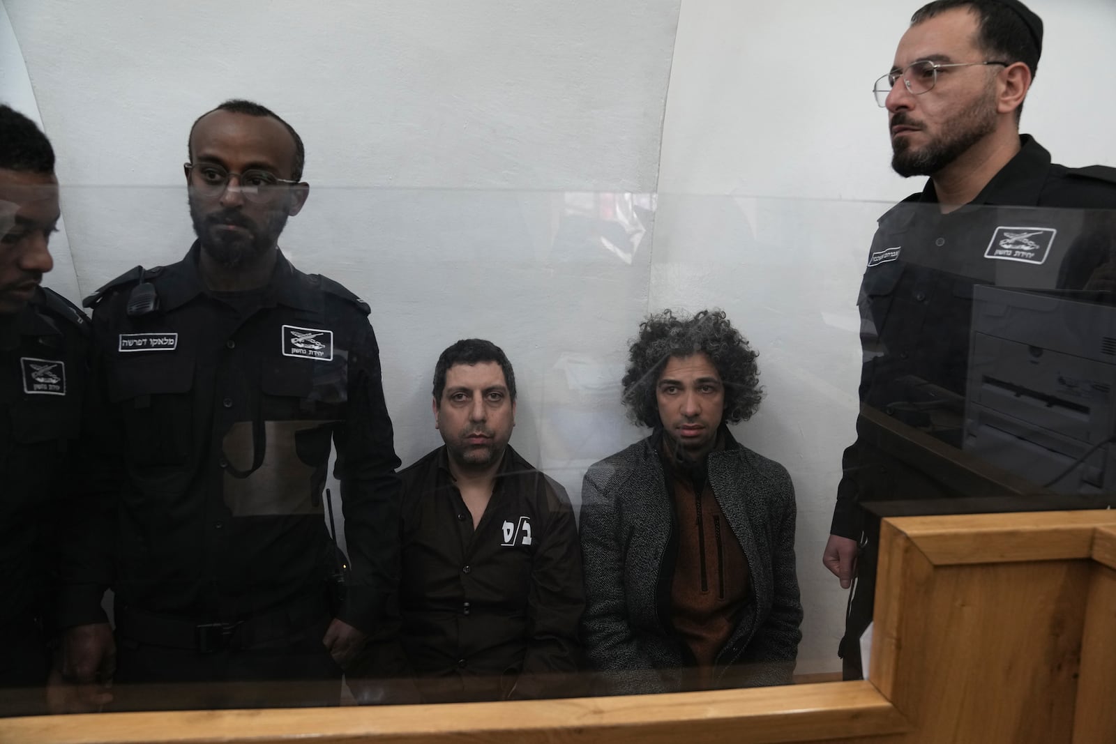 Booksellers Ahmad, left, and Mahmoud Muna appear in court after their arrest during an Israeli police have raid of their long-established Palestinian-owned Educational Bookshop in east Jerusalem, Monday, Feb. 10, 2025. (AP Photo/Mahmoud Illean)