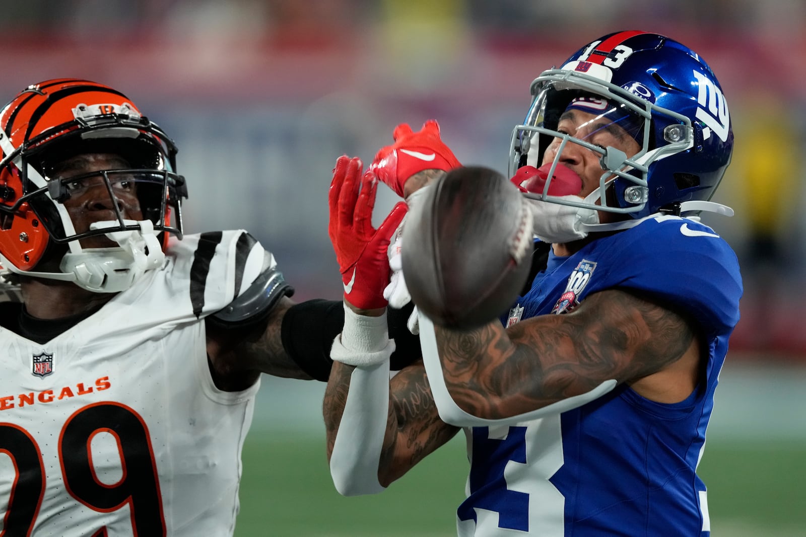 New York Giants wide receiver Jalin Hyatt (13) is unable to make the catch as Cincinnati Bengals cornerback Cam Taylor-Britt (29) defends during the second half of an NFL football game, Sunday, Oct. 13, 2024, in East Rutherford, N.J. (AP Photo/Seth Wenig)