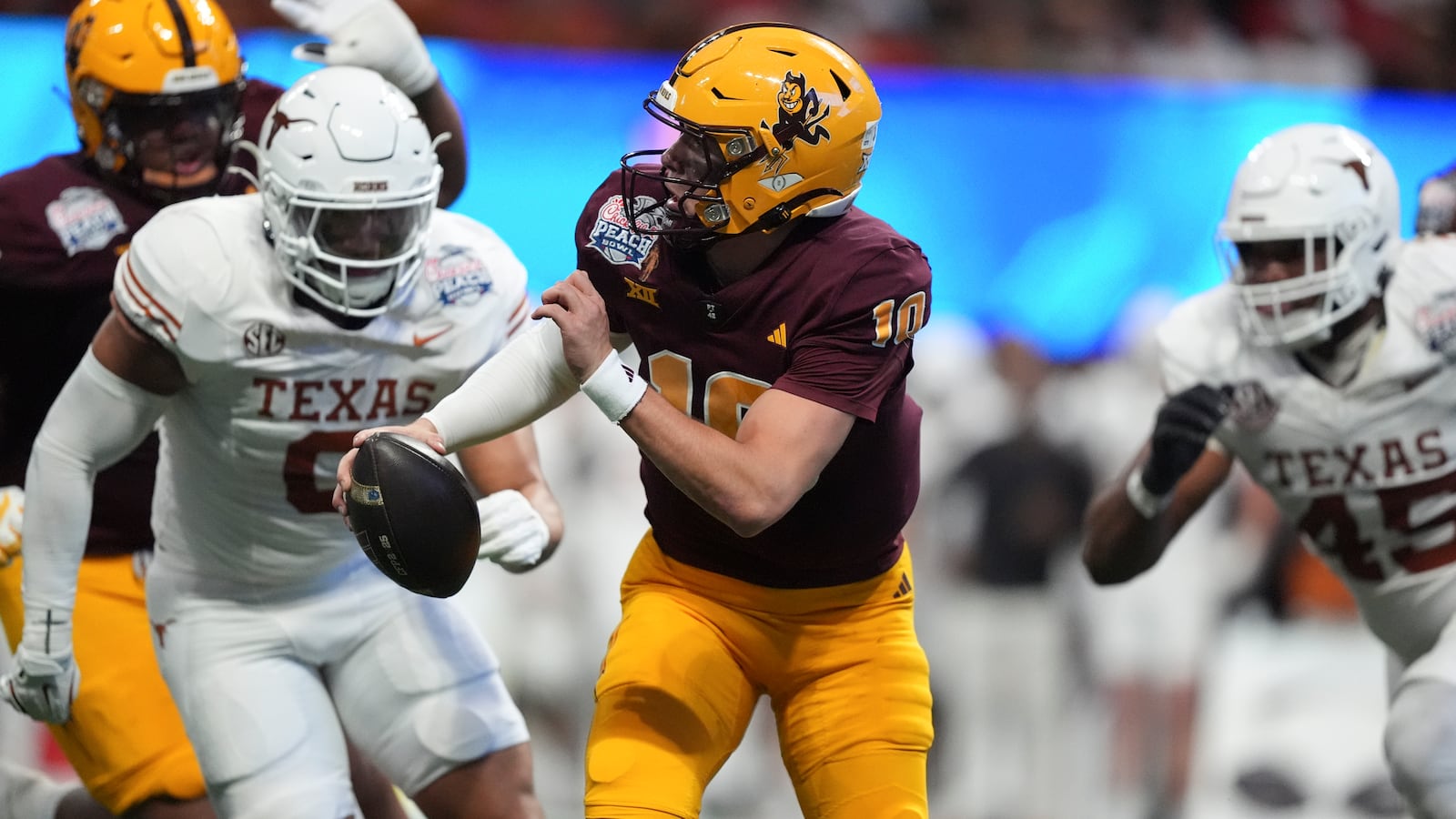 Arizona State quarterback Sam Leavitt (10) runs under pressure from against Texas during the first half in the quarterfinals of a College Football Playoff, Wednesday, Jan. 1, 2025, in Atlanta. (AP Photo/Brynn Anderson)