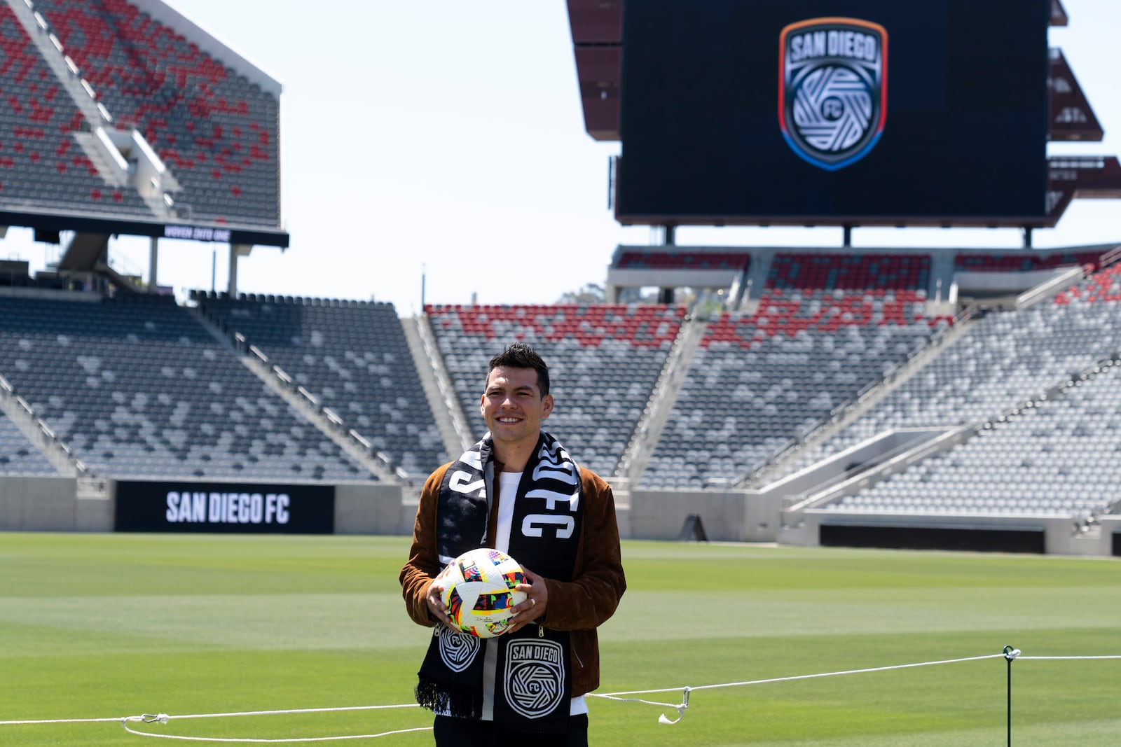 FILE - Hirving "Chucky" Lozano poses with a San Diego FC scarf during an introductory news conference for the new MLS soccer team Thursday, June 13, 2024, in San Diego. \ (AP Photo/Gregory Bull, FIle)