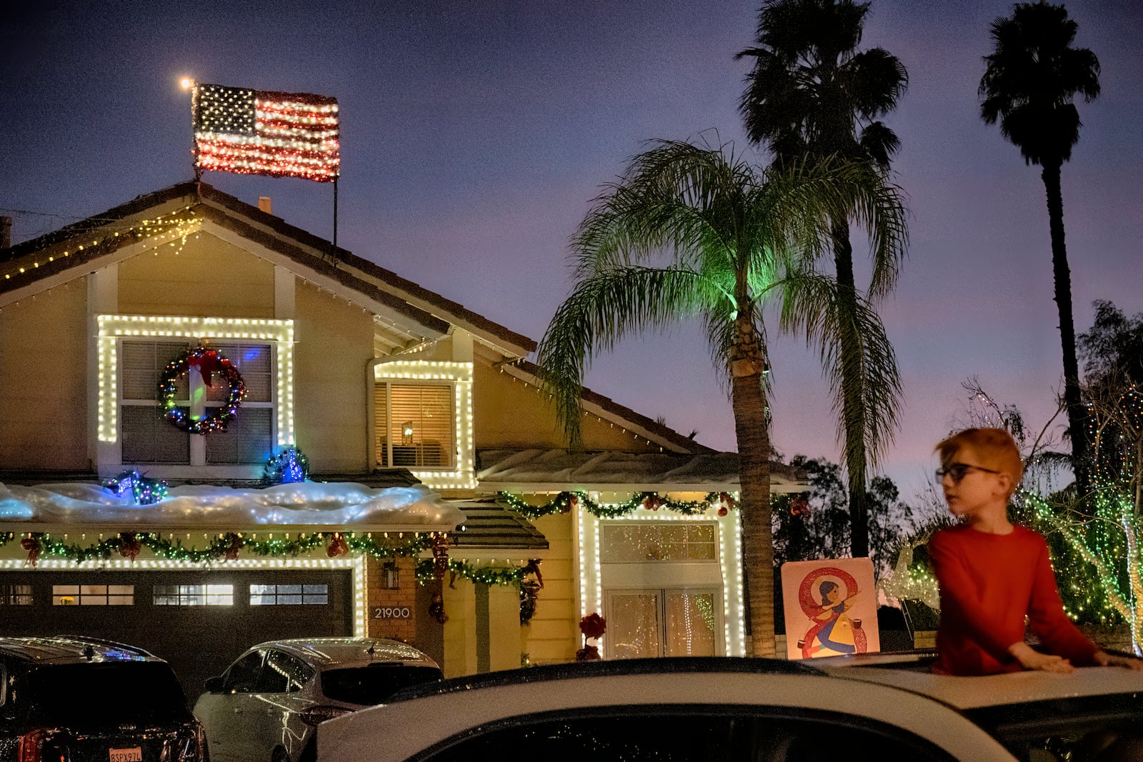 Local residents drive through the Wakefield Winter Wonderland neighborhood decorated with Christmas lights in Santa Clarita, Calif. on Dec. 17, 2024. (AP Photo/Richard Vogel)