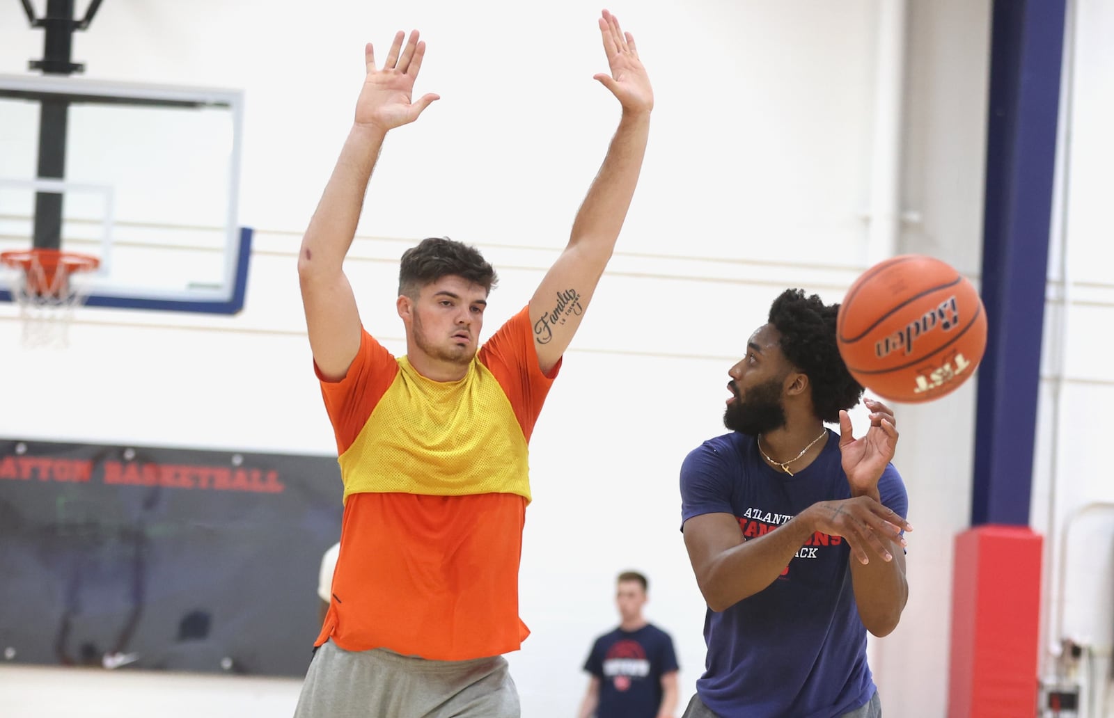 Grant Basile, left, and Josh Cunningham practice with the Red Scare for The Basketball Tournament on Tuesday, July 16, 2024, at the Cronin Center in Dayton. David Jablonski/Staff