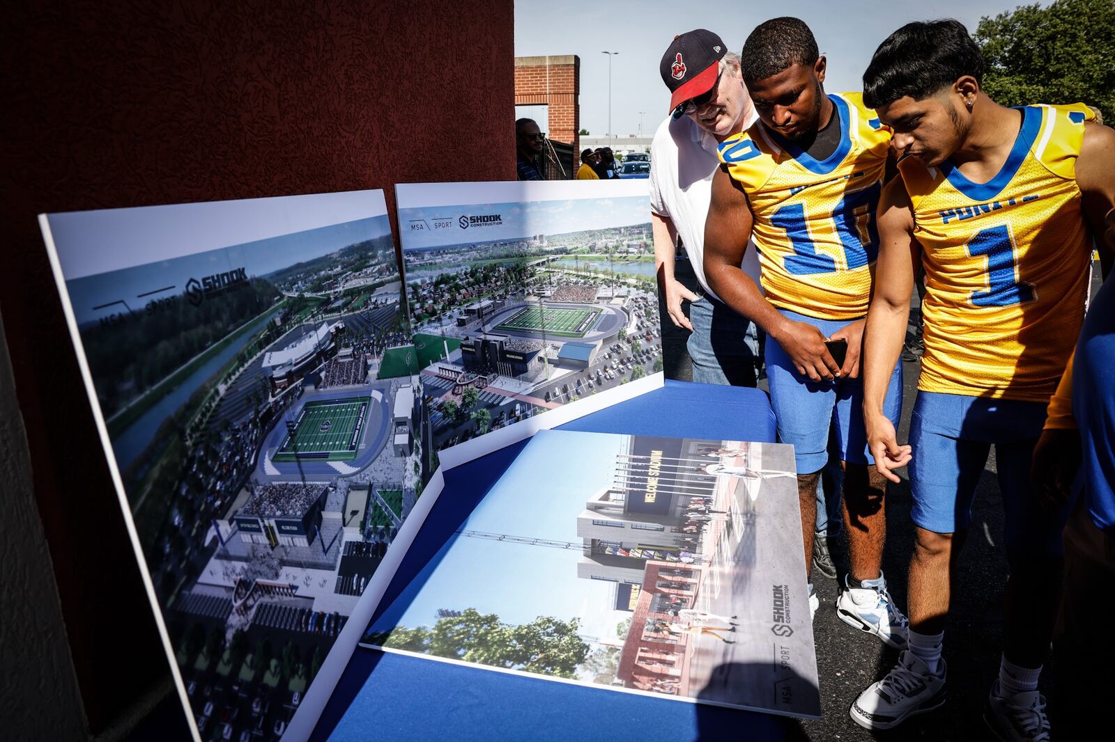 Ponitz High School athletes checkout the renderings of the Welcome Stadium renovation which was kickoff Wednesday afternoon following a groundbreaking ceremony.  JIM NOELKER/STAFF