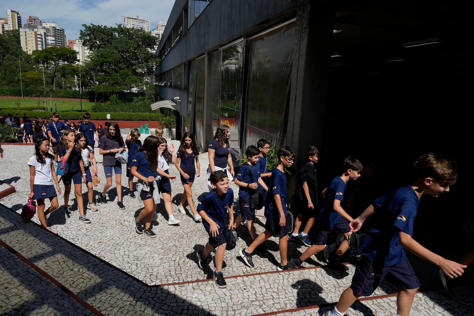 Students return to class after recess during their first week in school under a new law restricting the use mobile phones in school classrooms at Porto Seguro School in Sao Paulo, Thursday, Feb. 6, 2025. (AP Photo/Andre Penner)