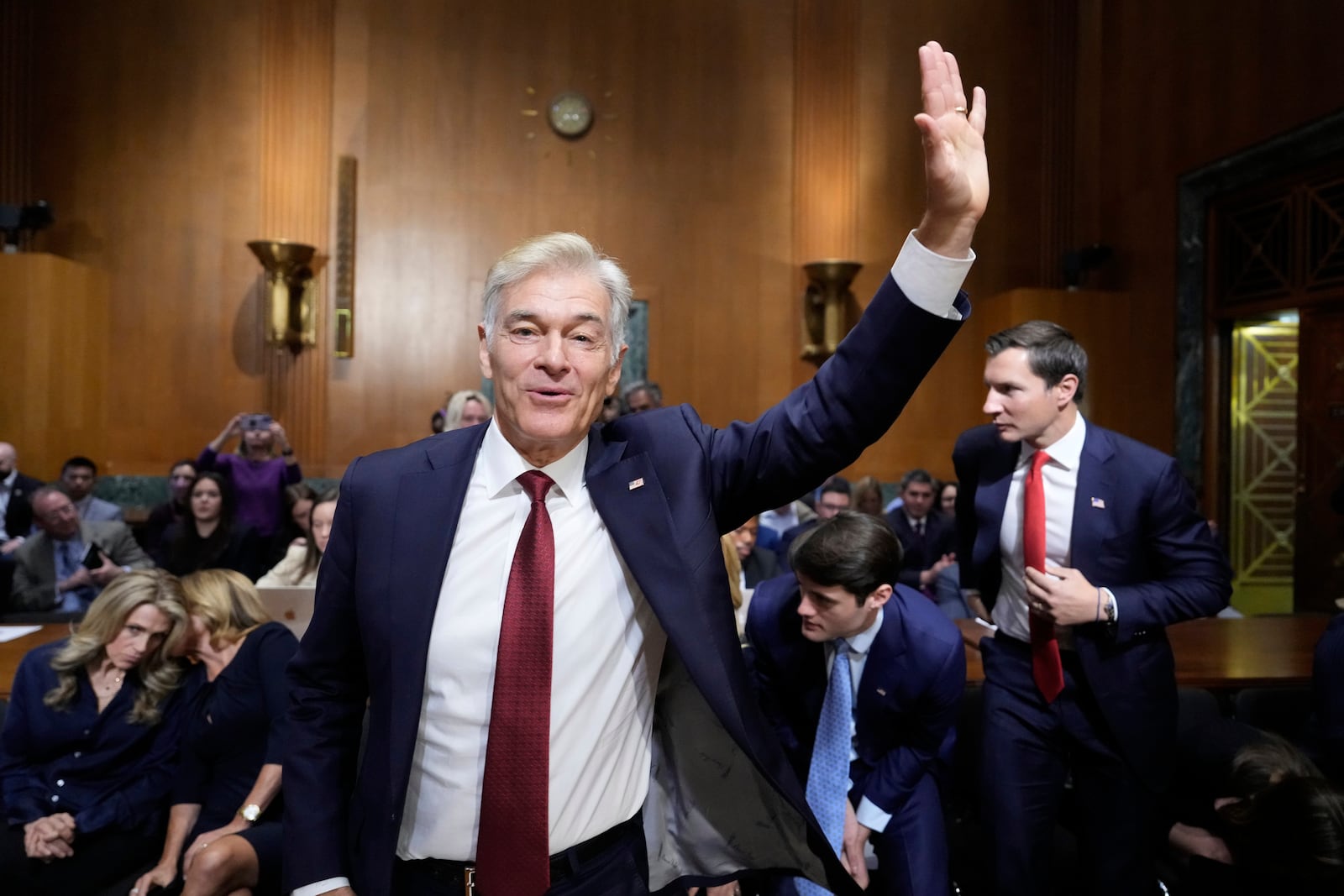 Dr. Mehmet Oz, President Donald Trump's pick to lead the Centers for Medicare and Medicaid Services, waves at the conclusion of his confirmation hearing before the Senate Finance Committee, on Capitol Hill in Washington, Friday, March 14, 2025. (AP Photo/Ben Curtis)