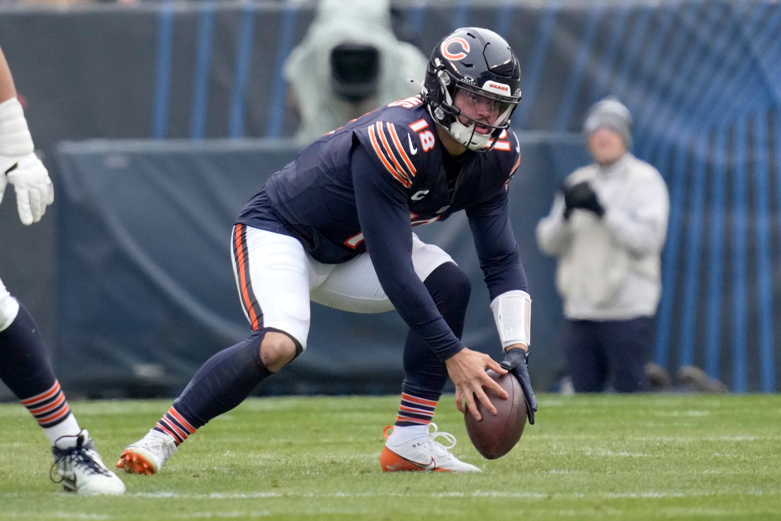 Chicago Bears quarterback Caleb Williams recovers a bad snap from center during the first half of an NFL football game against the Detroit Lions on Sunday, Dec. 22, 2024, in Chicago. (AP Photo/Nam Y. Huh)