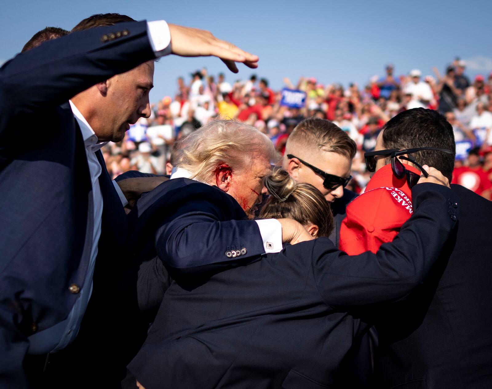 
                        Secret Service agents surround former President Donald Trump after being shot during a campaign rally in Butler, Pa., Saturday, July 13, 2024.  Immediately following Saturday’s shooting a bipartisan pair of lawmakers in the House said they have plans to introduce a bill that would enhance the secret service protection for both President Biden and Mr. Trump. (Doug Mills/The New York Times)
                      