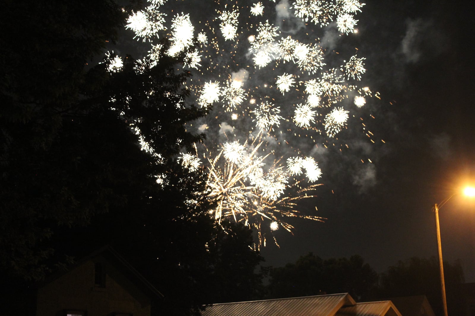 Fireworks go off in the city of Dayton on Sunday, July 4, as seen from a residential neighborhood. Cornelius Frolik / Staff