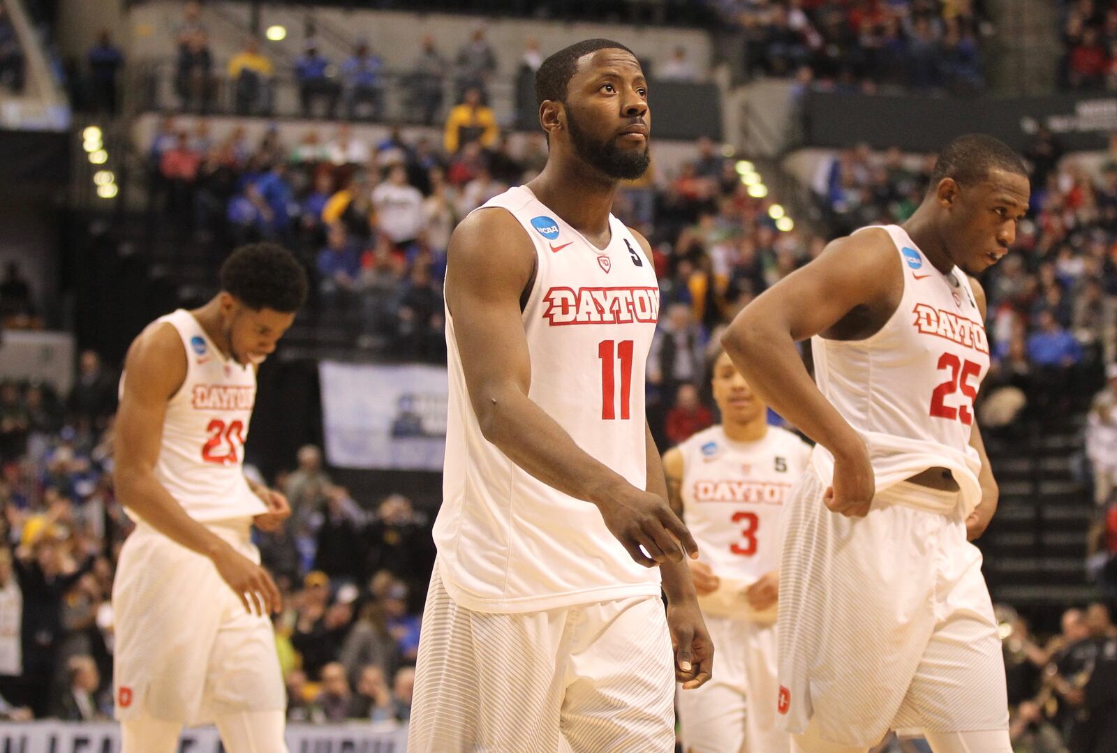 Dayton players, including senior Scoochie Smith, center, leave the court after a loss against Wichita State in the first round of the NCAA tournament on Friday, March 17, 2017, at Bankers Life Fieldhouse in Indianapolis. David Jablonski/Staff