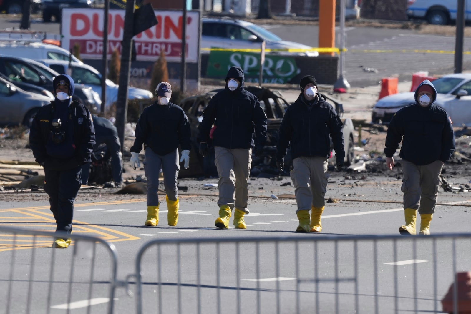 Investigators work the scene where a small plane crashed in Philadelphia, Saturday, Feb. 1, 2025. (AP Photo/Matt Rourke)