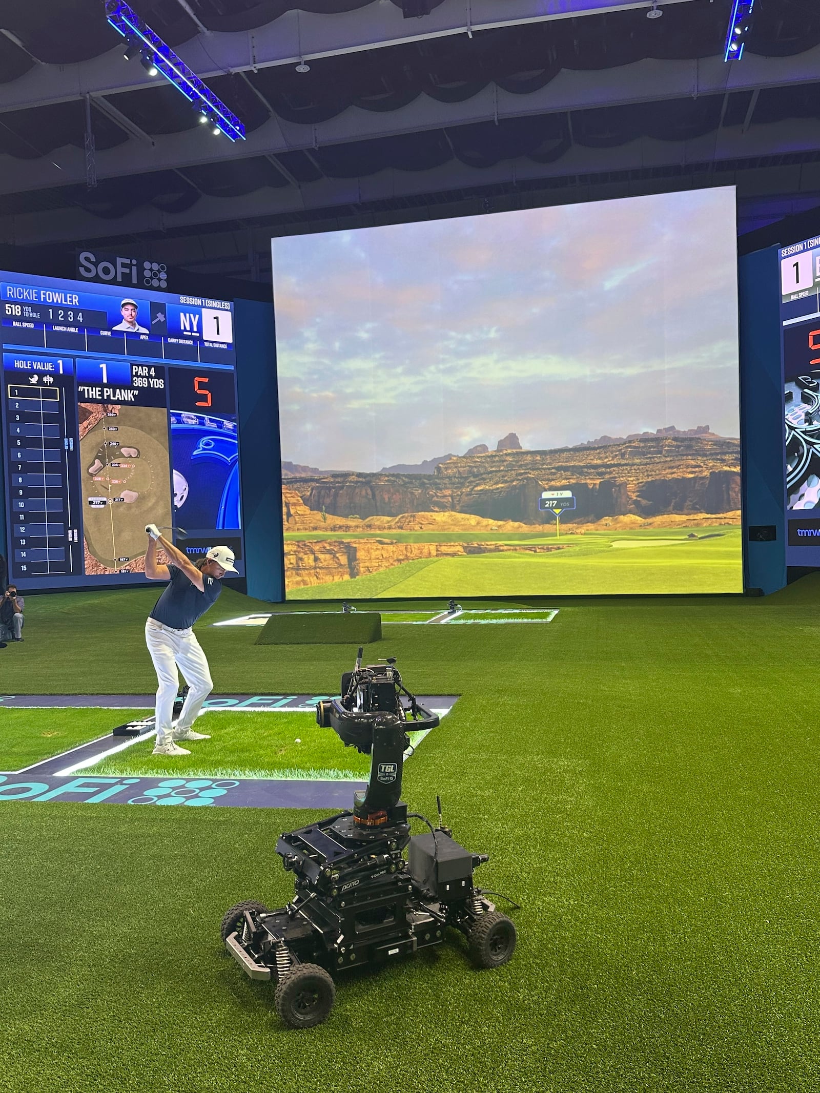 Rickie Fowler hits into the massive simulator screen at the SoFi Center in Palm Beach Gardens, Fla, on Dec. 18, 2024. The 250,000-square-foot complex holds the new TMRW Golf League co-owned by Tiger Woods and Rory McIlroy. The first match is Jan. 7, 2025 in prime time on ESPN. (AP Photo/Doug Ferguson)