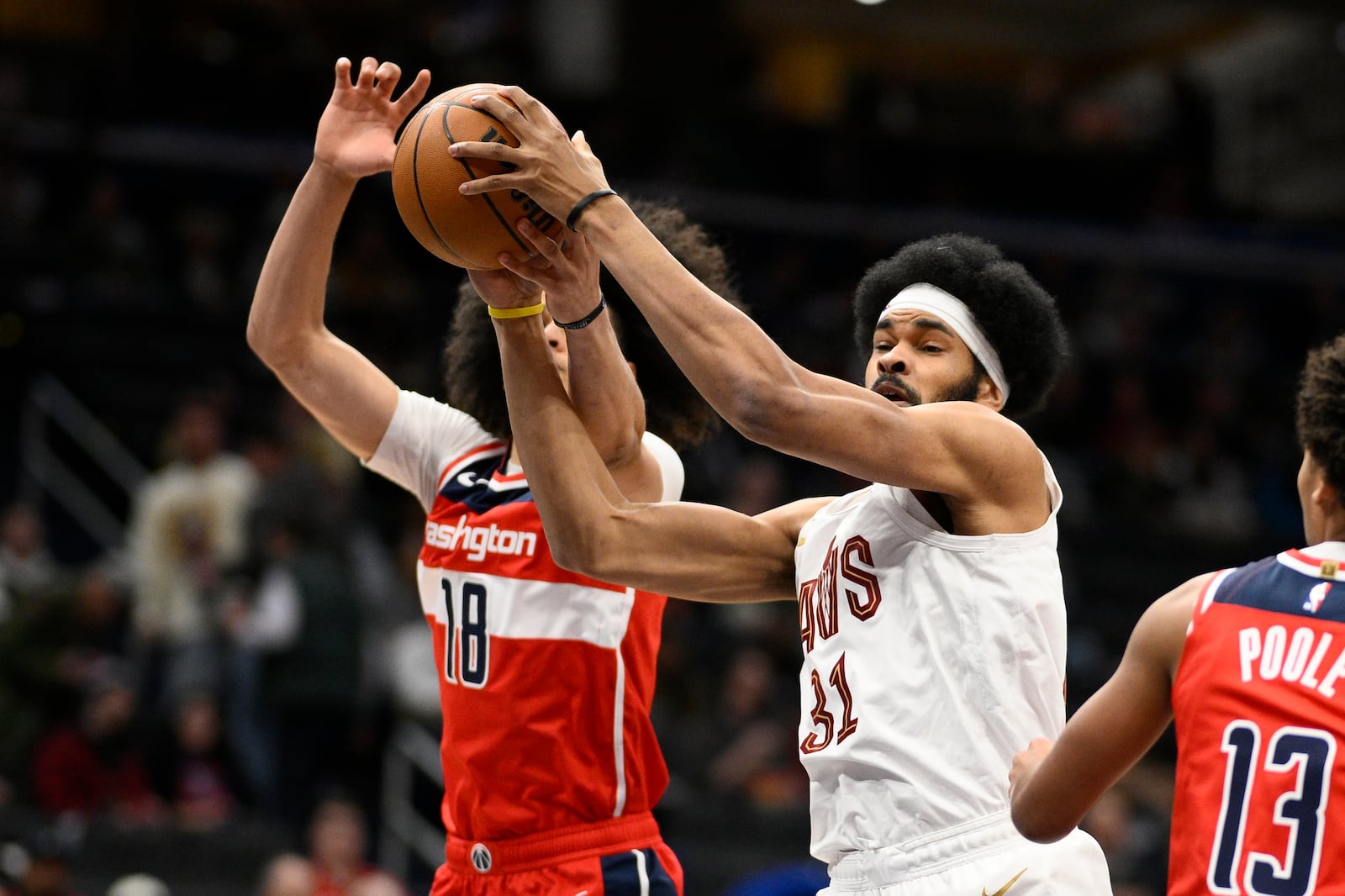 Cleveland Cavaliers center Jarrett Allen (31) battles for the ball against Washington Wizards forward Kyshawn George (18) during the first half of an NBA basketball game, Friday, Feb. 7, 2025, in Washington. (AP Photo/Nick Wass)