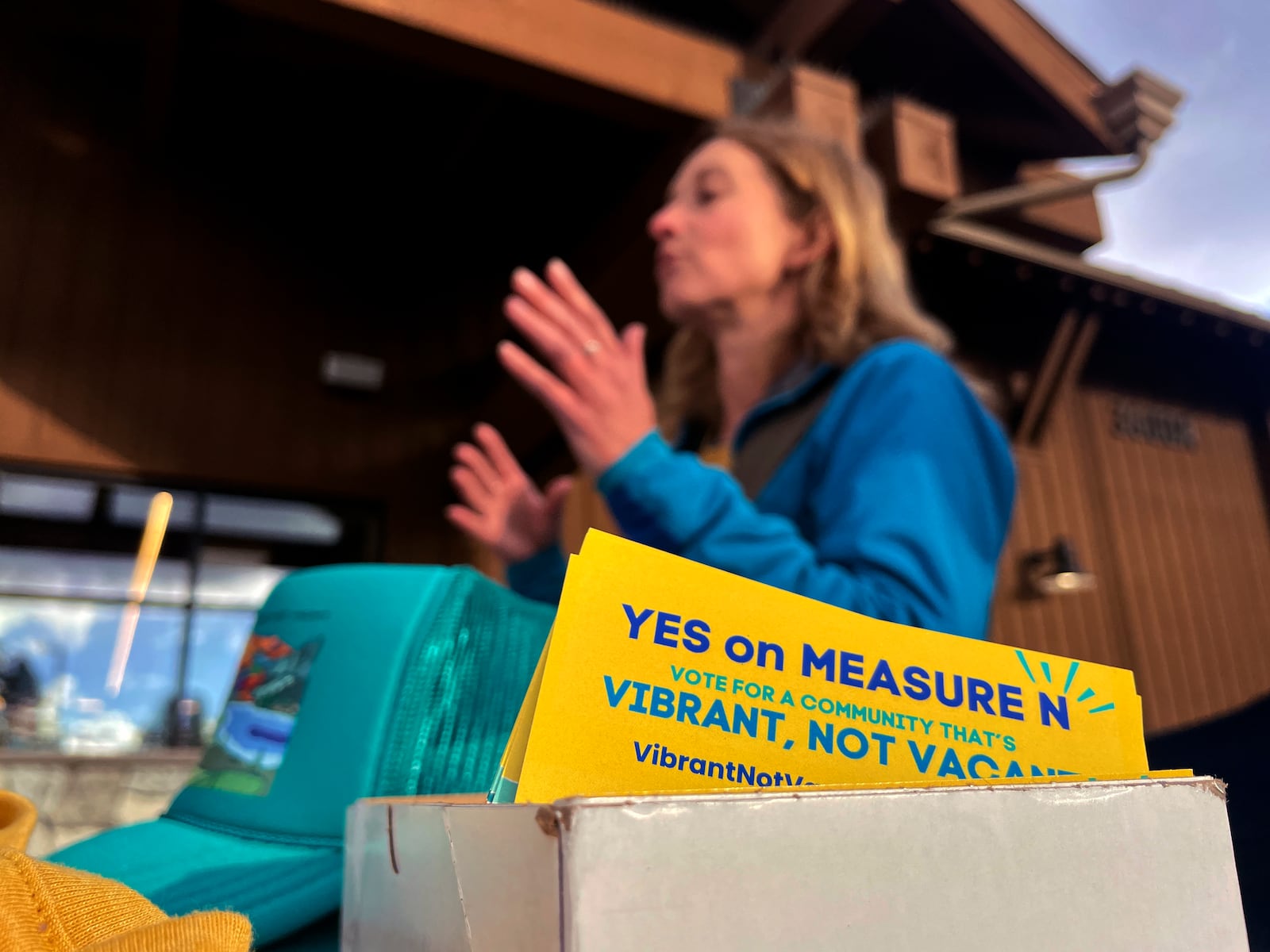 Amelia Richmond, Co-Founder, Locals for Affordable Housing, talks to a voter outside a grocery store in South Lake Tahoe, Calif. on Thursday, Oct. 17, 2024, where voters will decide whether to approve Measure N, which will mandate a tax to homeowners who leave their homes vacant for more than half the year.v(AP Photo/Haven Daley)