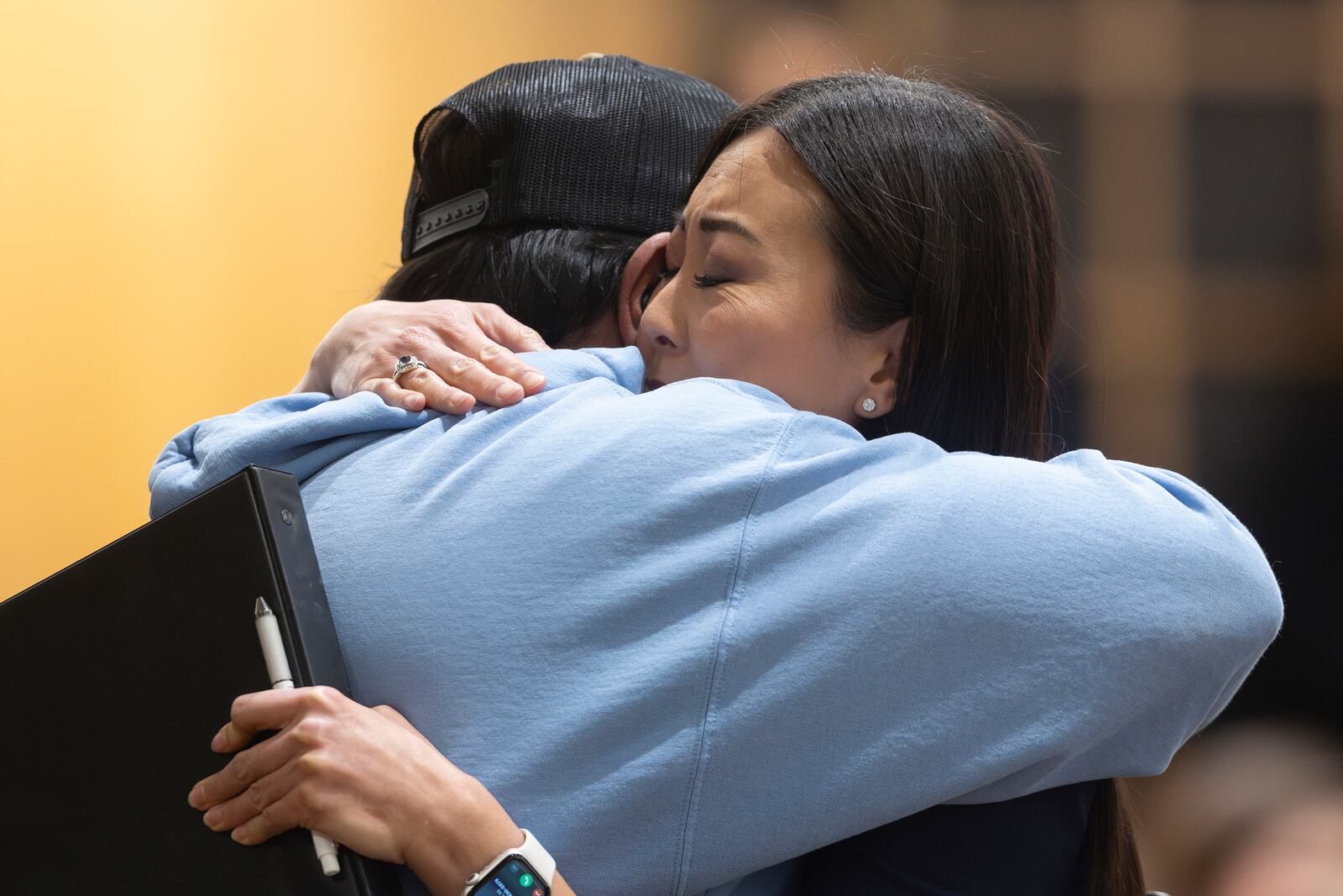 Wichita mayor Lily Wu hugs Pastor Albert Paredes during a prayer vigil in Wichita, Kan., on Thursday, Jan. 30, 2025, for those affected by the crash of American Airlines flight 5342 near Washington the day before. (AP Photo/Travis Heying)