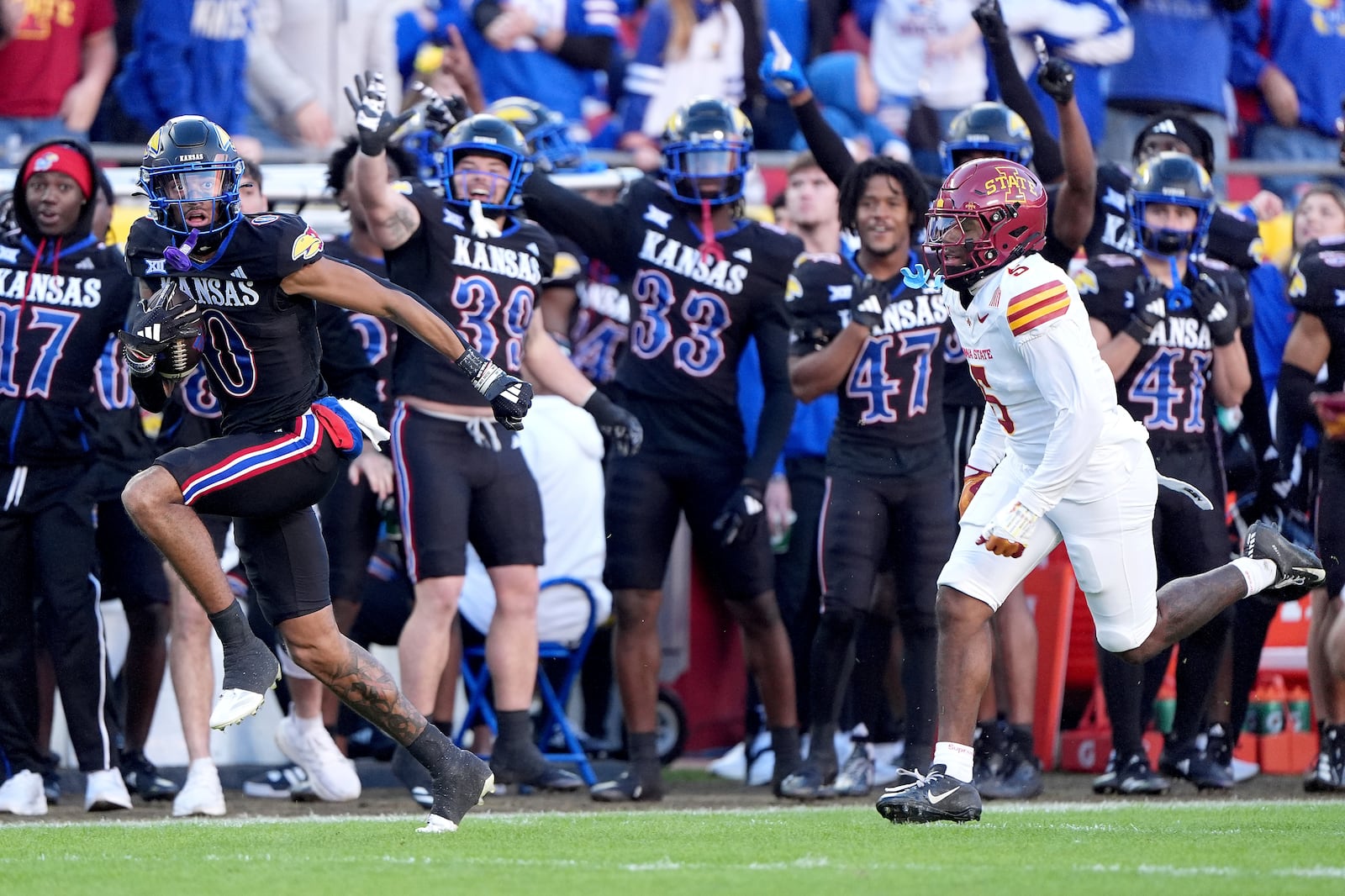 Kansas wide receiver Quentin Skinner (0) is chased by Iowa State defensive back Myles Purchase (5) as he runs for a first down during the first half of an NCAA college football game Saturday, Nov. 9, 2024, in Kansas City, Mo. (AP Photo/Charlie Riedel)