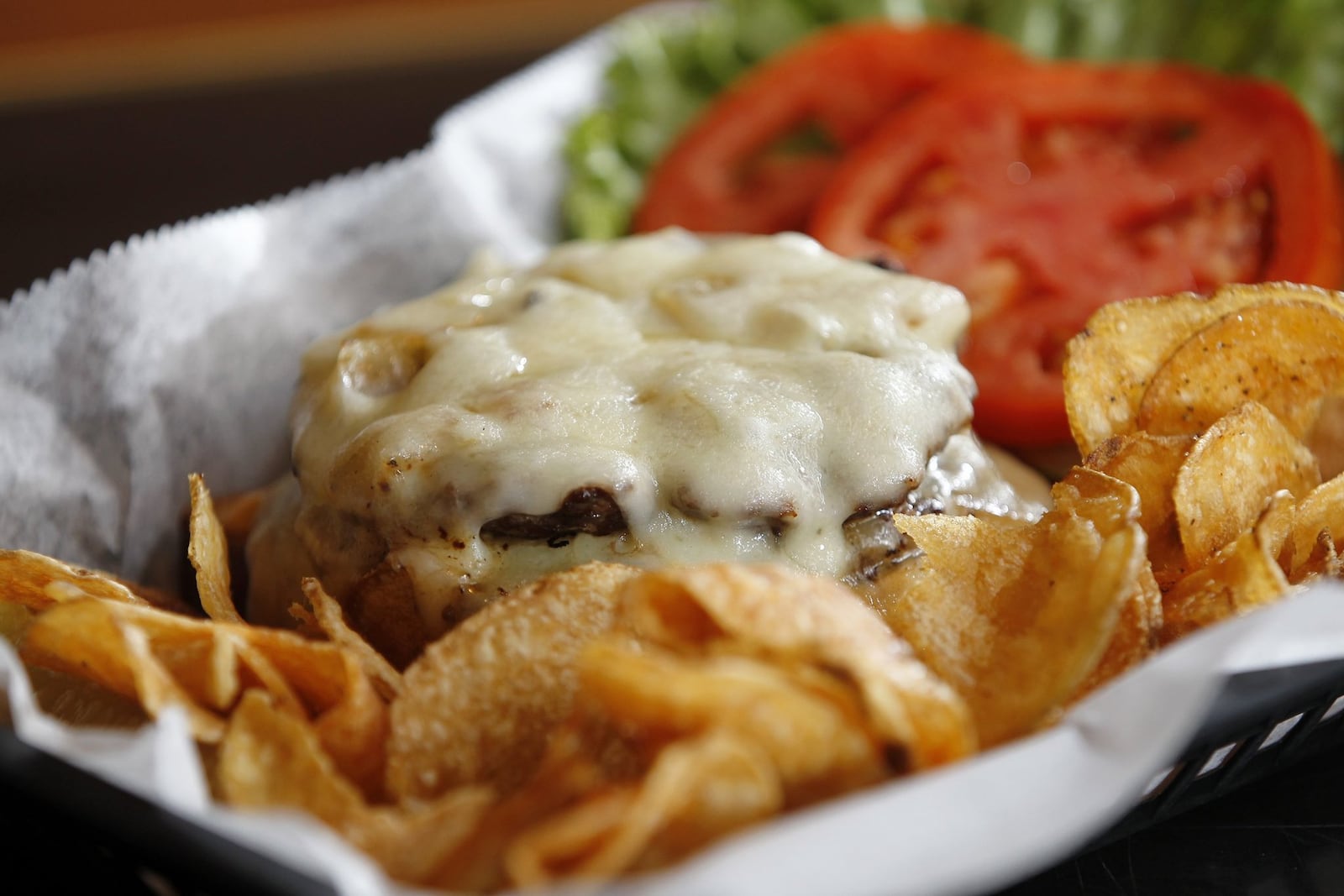 The Frisco burger at Blind Bob’s in the Oregon District is served with sauteed onions, swiss cheese, Thousand Island dressing and grilled sourdough bread. LISA POWELL / STAFF