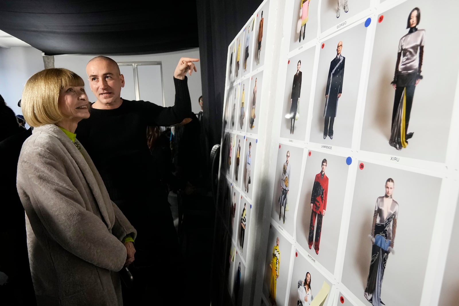 Fashion designer Francesco Risso gestures as he talks with Anna Wintour in the backstage prior a Marni Fall/Winter 2025-2026 Womenswear fashion show, during the Fashion Week, in Milan, Italy, Wednesday, Feb. 26, 2025. (AP Photo/Luca Bruno)