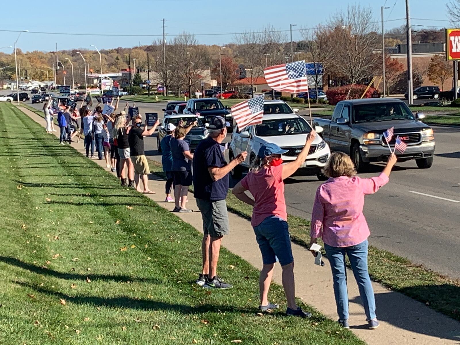 Supporters of the projected winner of the presidential race Joe Biden hold signs along Dorothy Lane in Kettering on Sunday, Nov. 8, in celebration. JOSH SWEIGART/STAFF