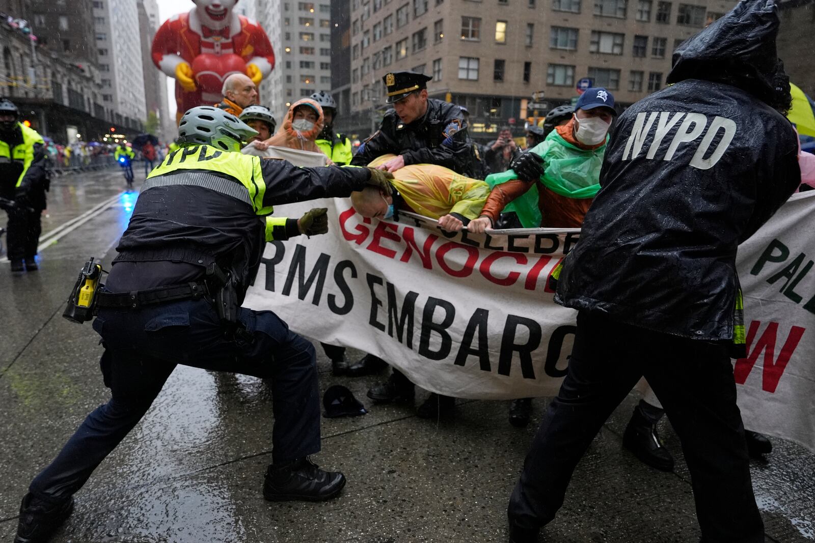 New York Police arrest Pro-Palestinian protesters who were demonstrating on Sixth Avenue during the Macy's Thanksgiving Day Parade, Thursday, Nov. 28, 2024, in New York. (AP Photo/Julia Demaree Nikhinson)