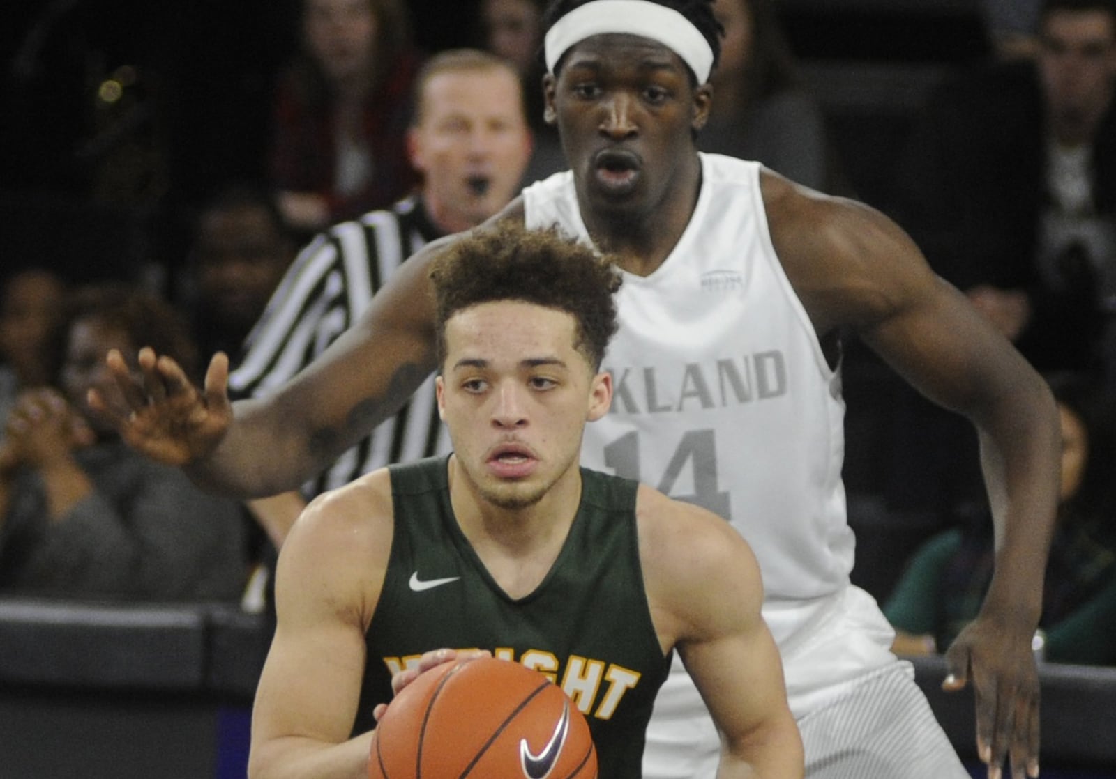 Wright State’s Justin Mitchell (with ball) pulls up in from of Oakland defender Xavier Hill-Mais. Oakland hosted WSU in a men’s college basketball Horizon League opener at Rochester, Mich., on Thursday, Dec. 29, 2016. MARC PENDLETON / STAFF