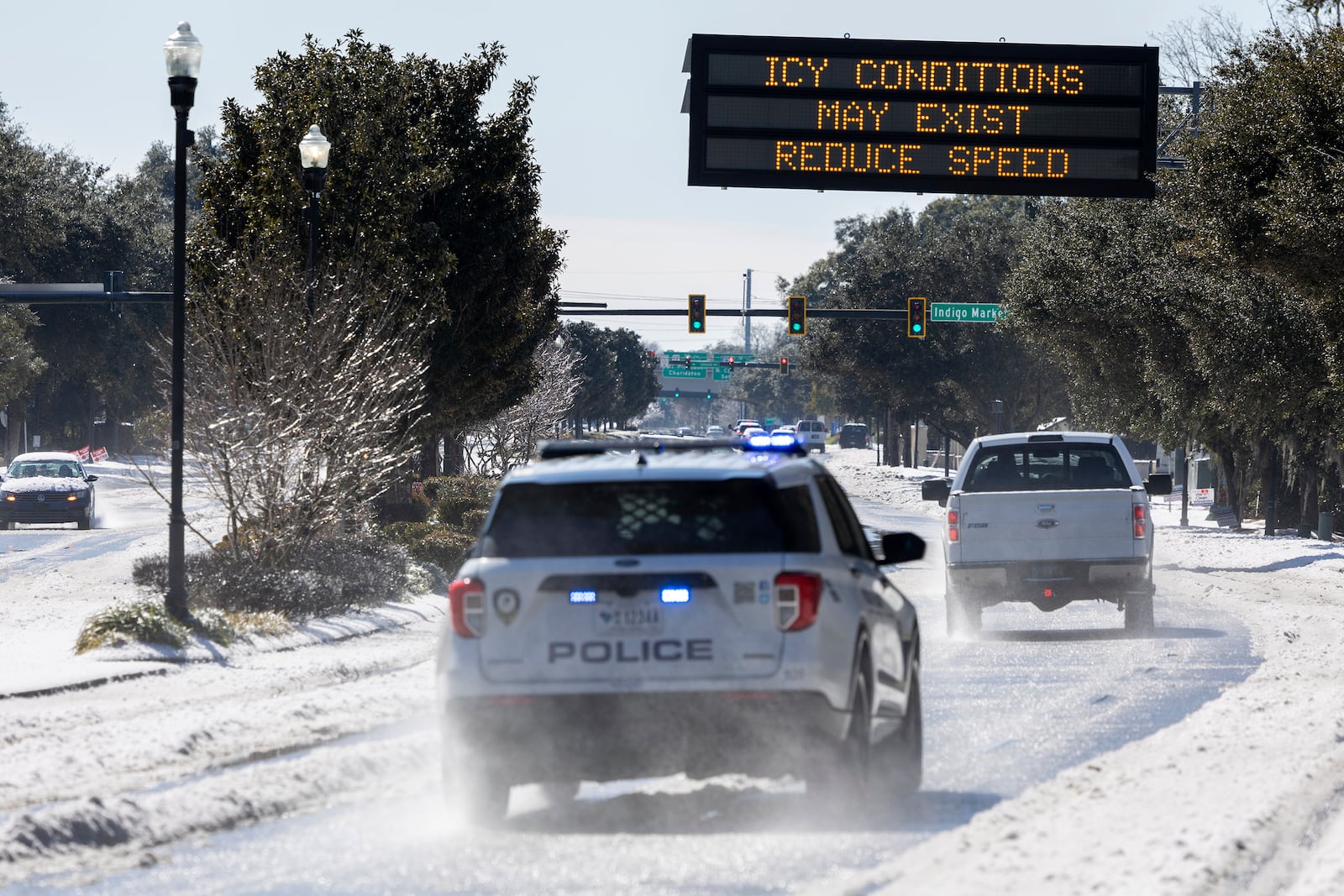 A highway sign alerts motorist to icy conditions on U.S. Highway 17 after a winter storm dropped ice and snow Wednesday, Jan. 22, 2025, in Mt. Pleasant, S.C. (AP Photo/Mic Smith)