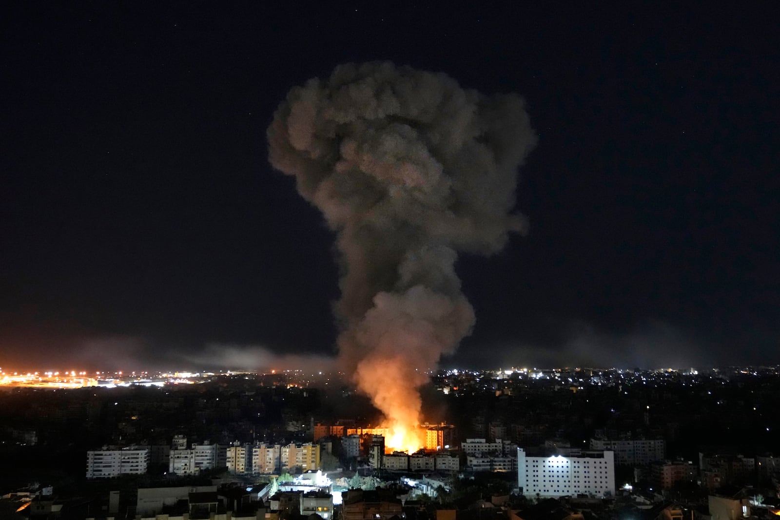 Flames and smoke rise from buildings hit by Israeli airstrikes on Dahiyeh, in the southern suburb of Beirut, Wednesday, Oct. 23, 2024. (AP Photo/Hussein Malla)