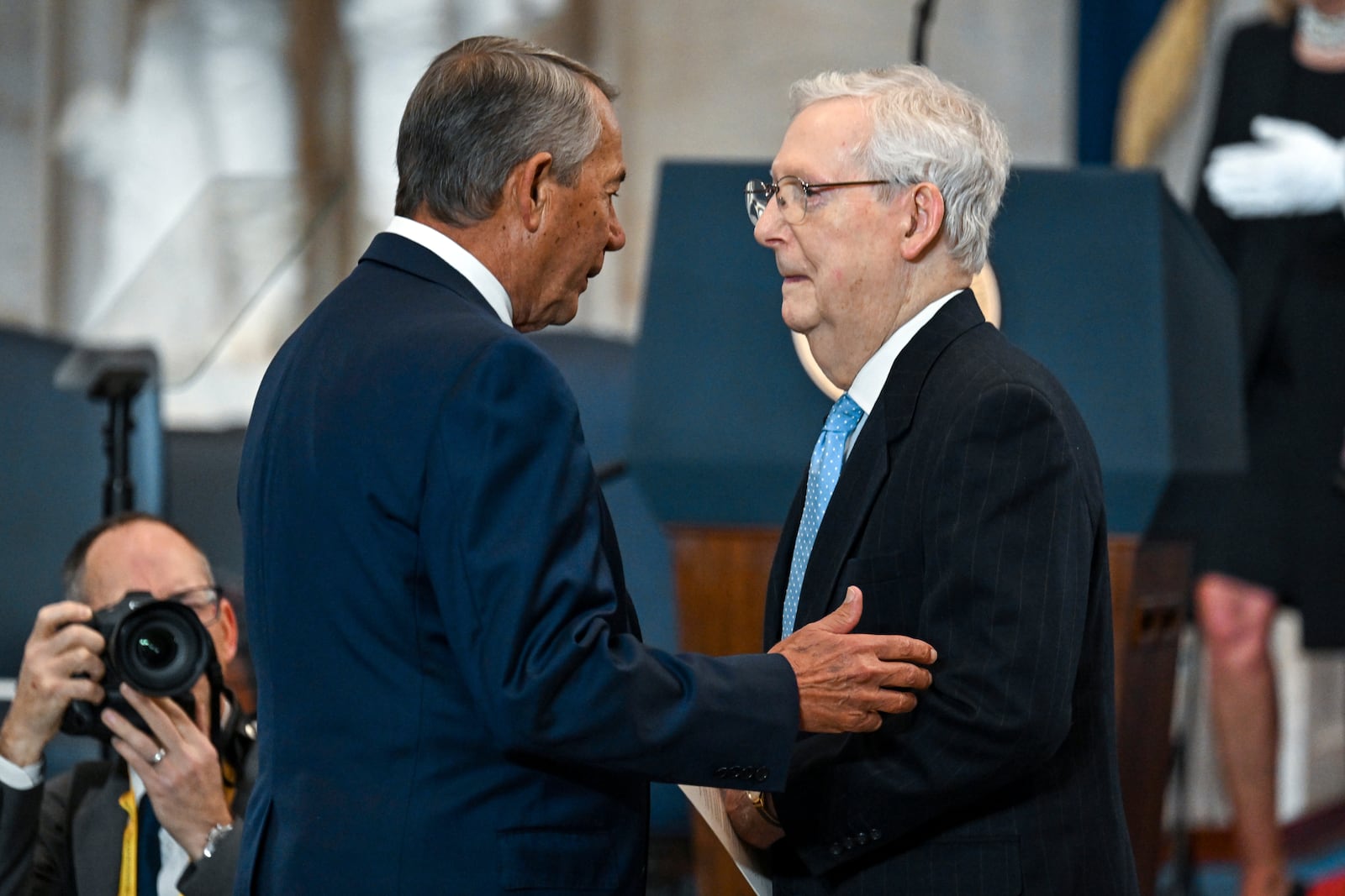 Former House Speaker John Boehner, left, greets Sen. Mitch McConnell, R-Ky., before the 60th Presidential Inauguration in the Rotunda of the U.S. Capitol in Washington, Monday, Jan. 20, 2025. (Kenny Holston/The New York Times via AP, Pool)