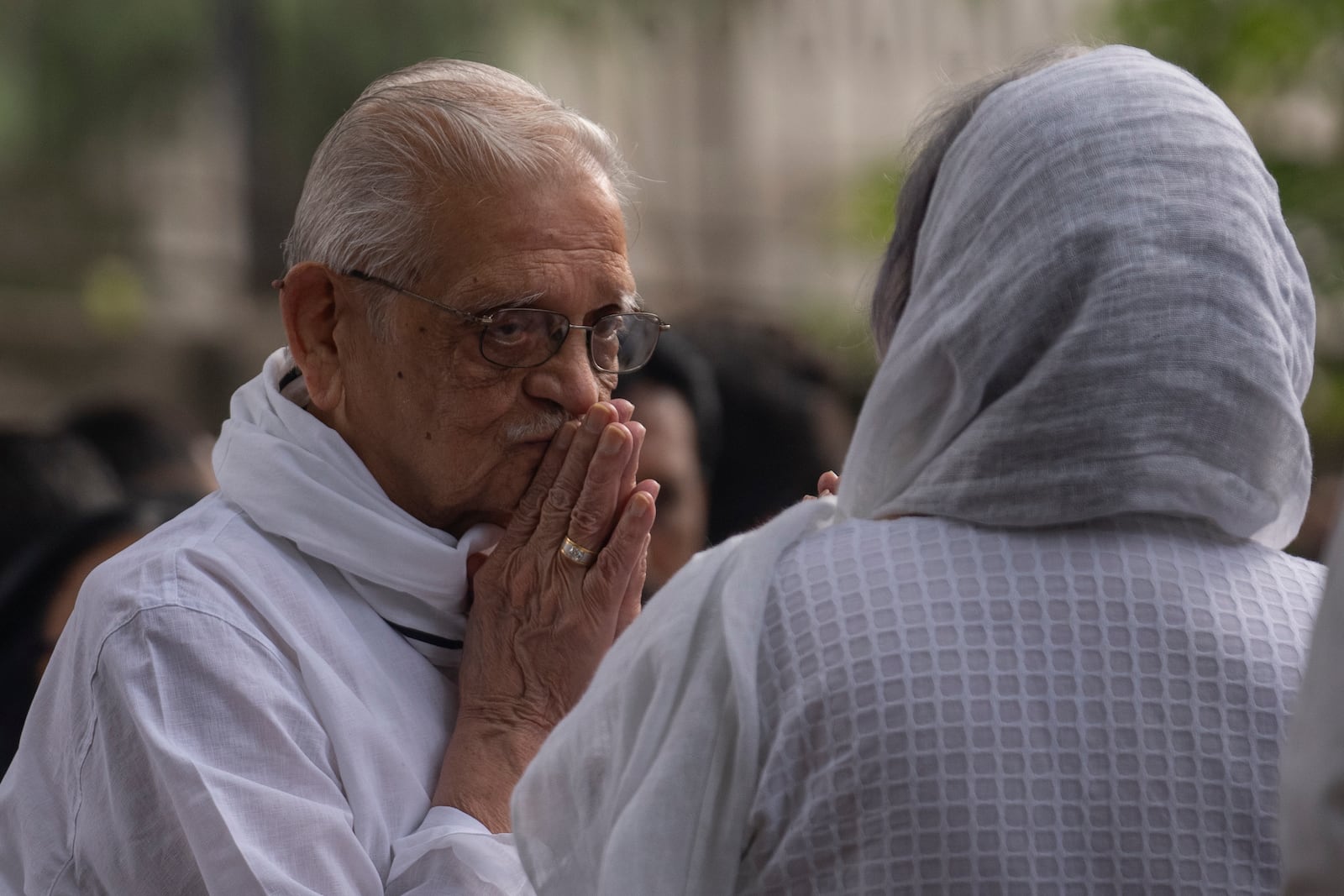 Indian film maker and poet Gulzar, left, pay homage to Shyam Benegal, a renowned Indian filmmaker who passed away on Monday, during Benegal's funeral in Mumbai, India, Tuesday, Dec. 24, 2024. (AP Photo/Rafiq Maqbool)