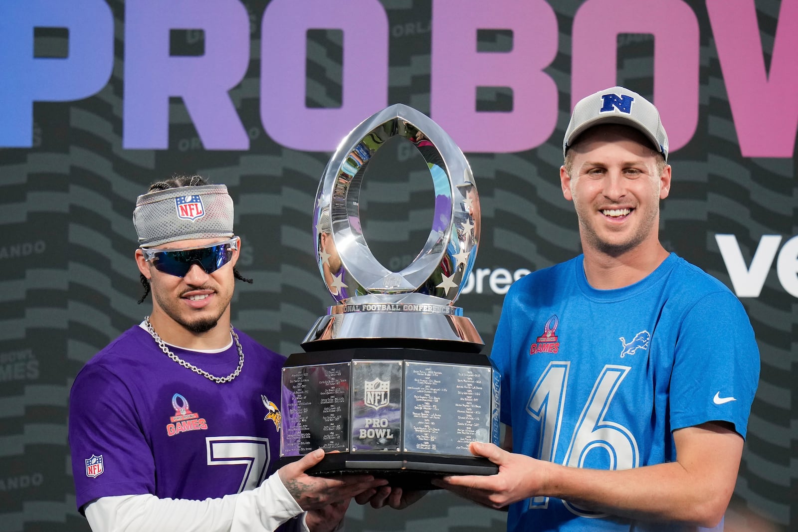 NFC cornerback Byron Murphy, left, of the Minnesota Vikings, and quarterback Jared Goff, right, of the Detroit Lions, hold the 2025 Pro Bowl trophy after being named defensive and offensive MVPs, respectively, for the flag football event at the NFL Pro Bowl, Sunday, Feb. 2, 2025, in Orlando. (AP Photo/Chris O'Meara)