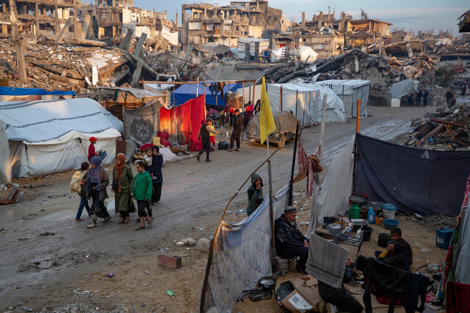 Palestinians walk along a street amid widespread destruction caused by the Israeli military's ground and air offensive against Hamas in Gaza City's Jabaliya refugee camp, Tuesday, Feb. 11, 2025. (AP Photo/Jehad Alshrafi)