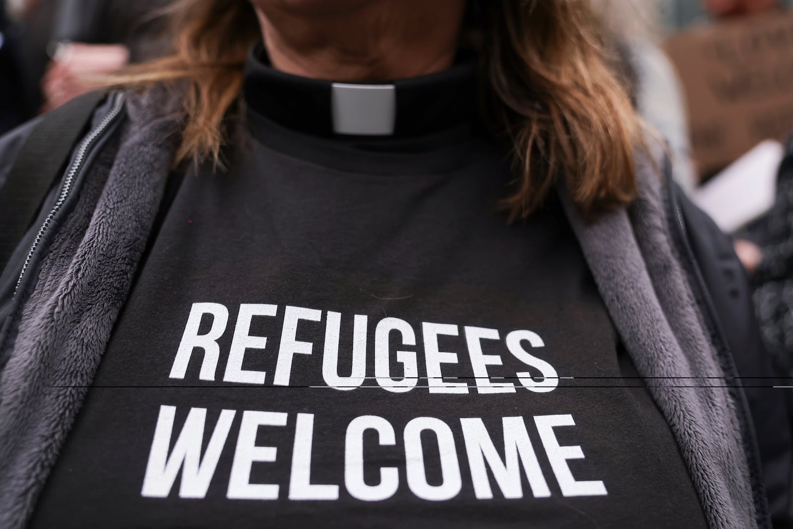 People gather outside the U.S. District Court after a federal judge blocked President Donald Trump's effort to halt the nation's refugee admissions system Tuesday, Feb. 25, 2025, in Seattle. (AP Photo/Ryan Sun)