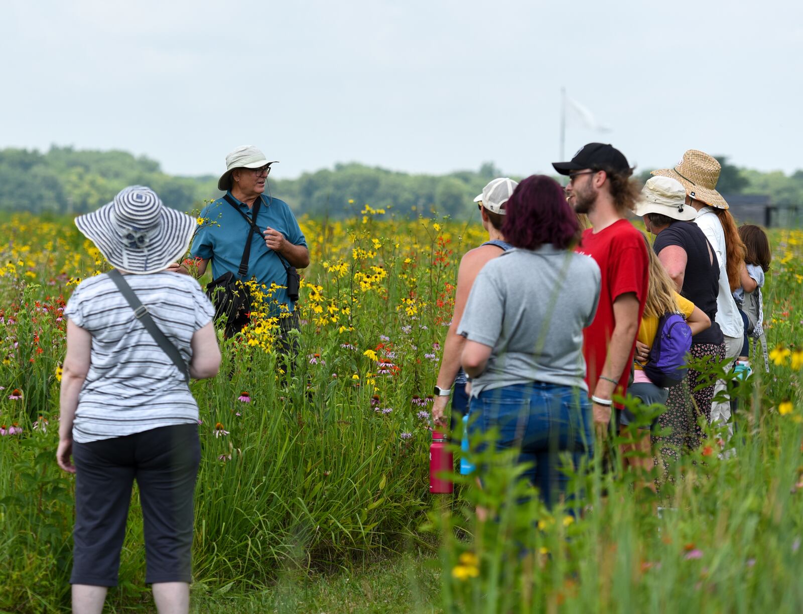 Dave Nolin, retired director of Five Rivers MetroParks, gives more than a dozen visitors an informative walking tour about the more than 300 species of wildflowers in Huffman Prairie, Wright-Patterson Air Force Base, Ohio, July 20, 2022. Huffman Prairie is the largest natural tall-grass prairie in Ohio. (U.S. Air Force photo by Matthew Clouse) 