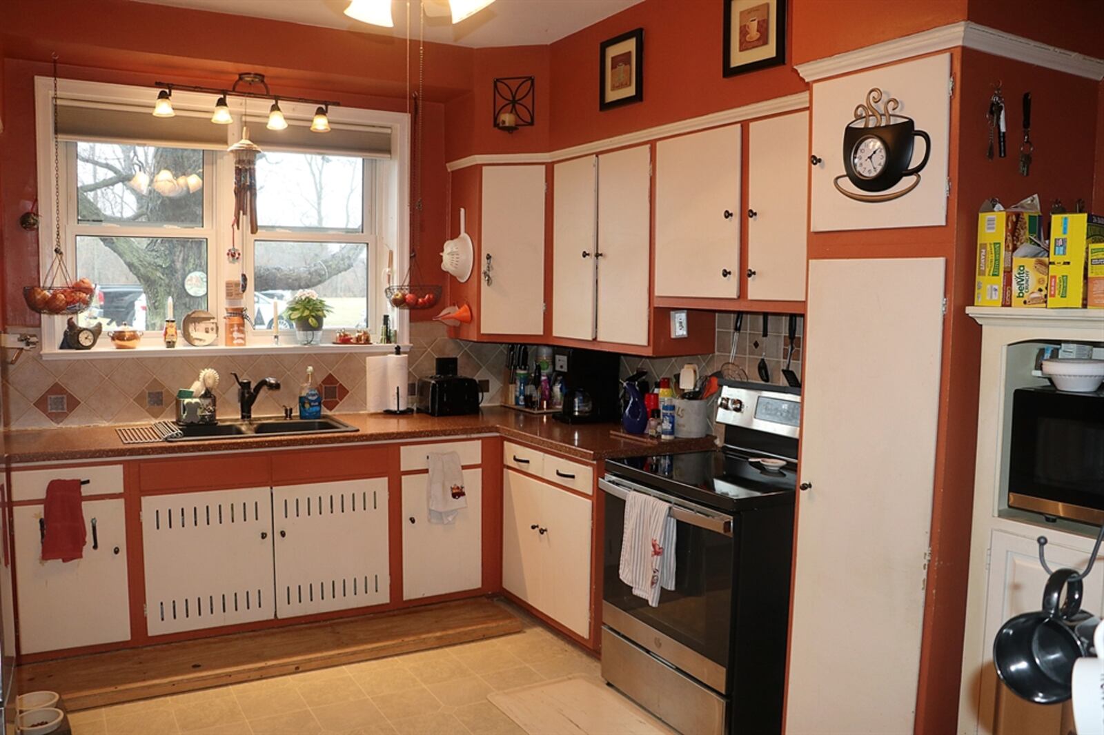 The kitchen is easily accessible from the dining area and has three walls of cabinetry and solid-surface counters.