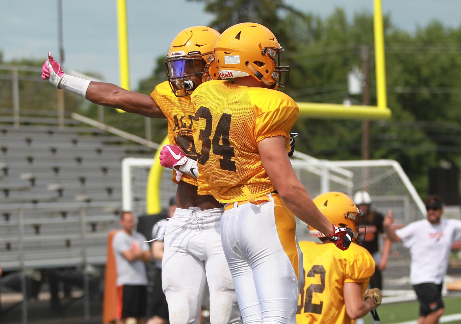 C.J. Hicks (left) and Seth Morris of Alter High School celebrate during a scrimmage at Beavercreek on Saturday, Aug. 17, 2019. MARC PENDLETON / STAFF