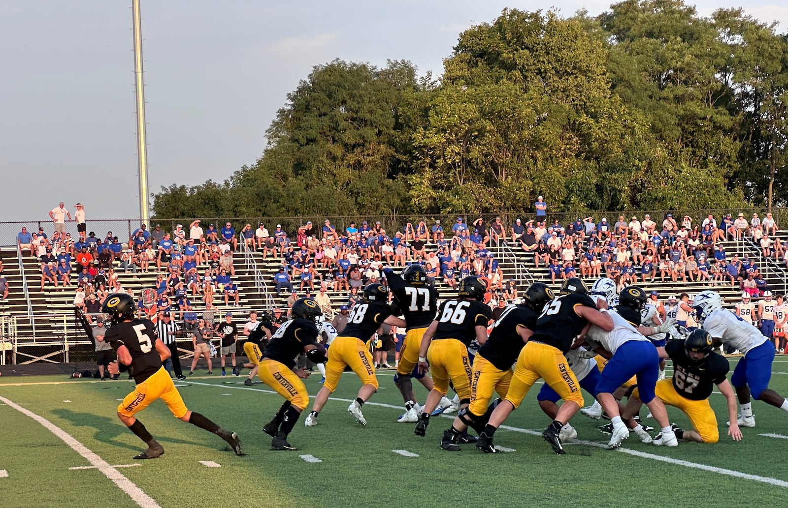 Parker Johnson takes a handoff for Centerville High School against St. Xavier High School in the first quarter of a football game Aug. 30, 2024 in Centerville.