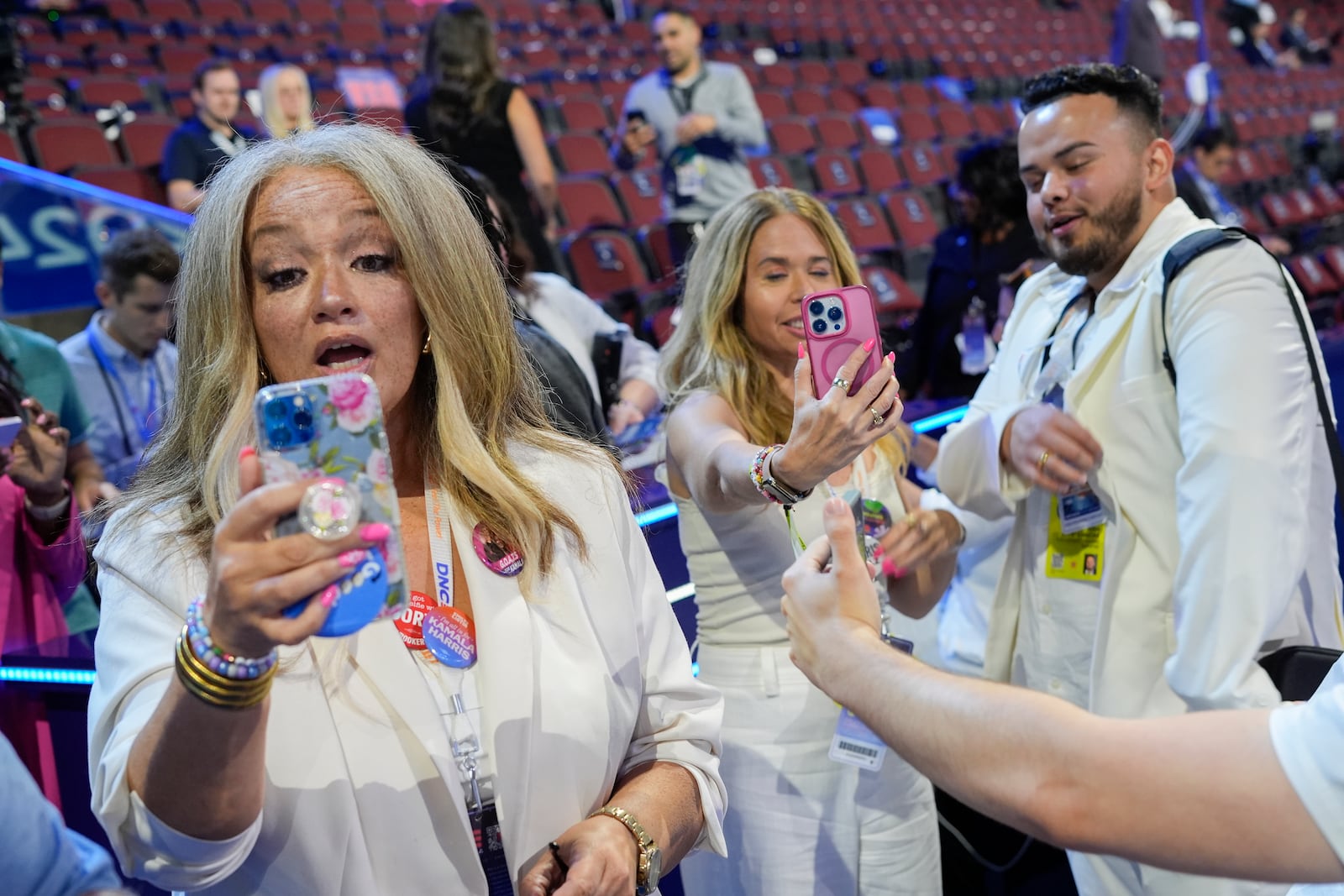 FILE - Content creators Kerry Robertson, from left, Sari Beth Rosenberg and Juan Acosta Macias are pictured during the Democratic National Convention in Chicago, Aug. 22, 2024. (AP Photo/Pablo Martinez Monsivais, File)